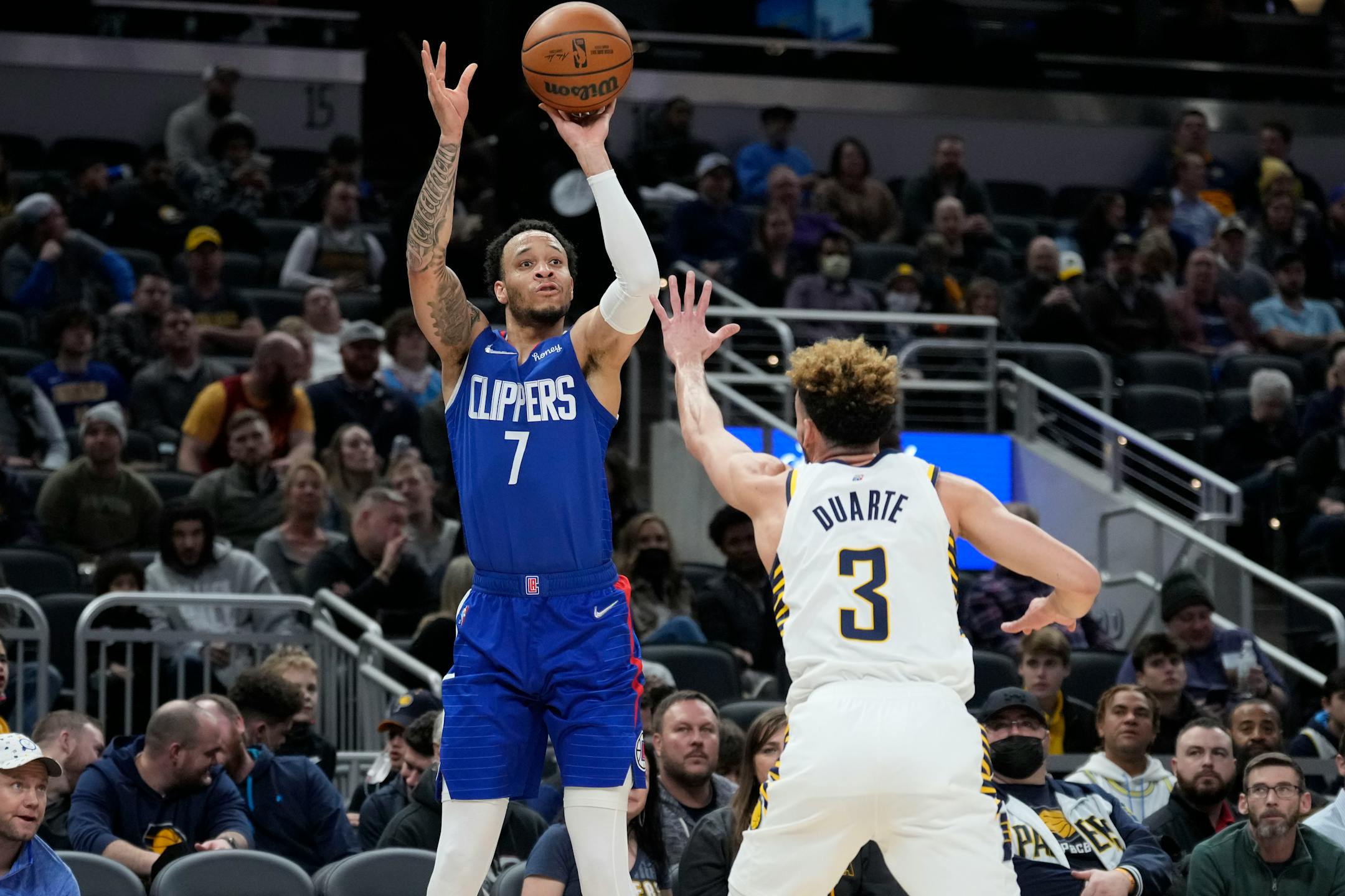 Los Angeles Clippers guard Amir Coffey (7) shoots over Indiana Pacers guard Chris Duarte (3) during the second half of an NBA basketball game in Indianapolis, Monday, Jan. 31, 2022. (AP Photo/AJ Mast)