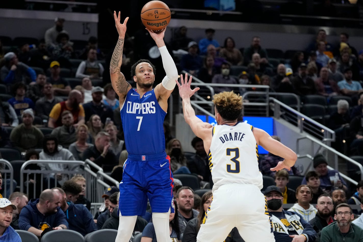 Los Angeles Clippers guard Amir Coffey (7) shoots over Indiana Pacers guard Chris Duarte (3) during the second half of an NBA basketball game in Indianapolis, Monday, Jan. 31, 2022. (AP Photo/AJ Mast)