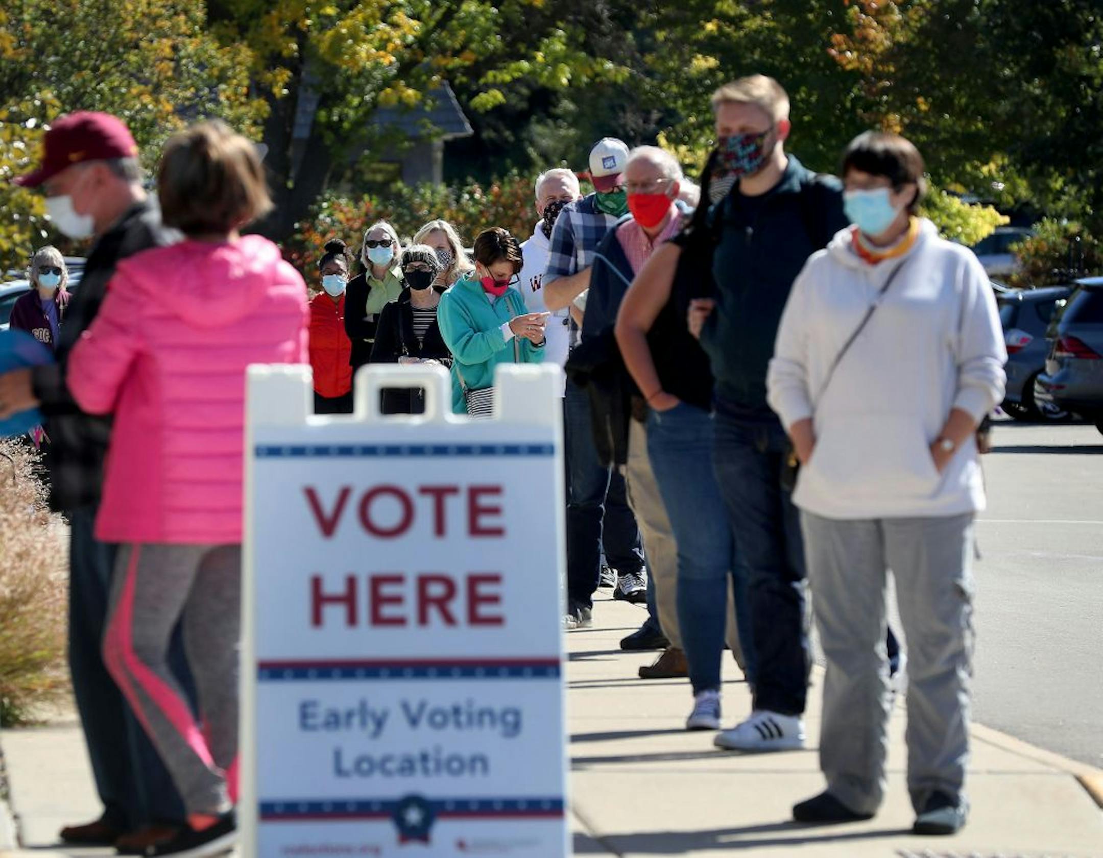 A long line of voters waited to cast their ballots during early voting at Ramsey County Library Friday in Roseville.