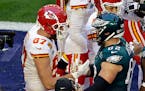 Kansas City Chiefs tight end Travis Kelce (87) embraces his brother Philadelphia Eagles center Jason Kelce (62) before the NFL Super Bowl 57 football 