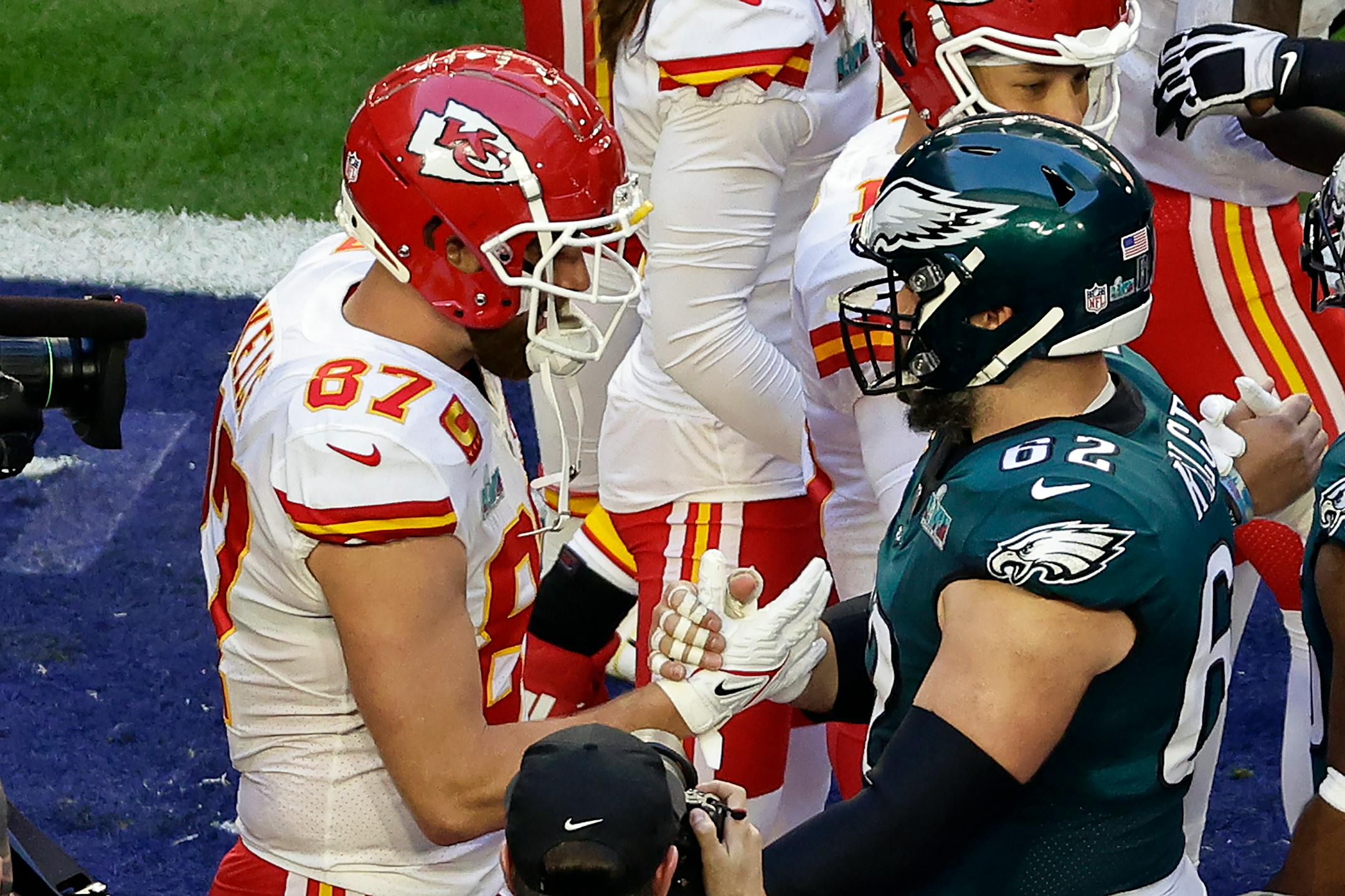 Kansas City Chiefs tight end Travis Kelce (87) embraces his brother Philadelphia Eagles center Jason Kelce (62) before the NFL Super Bowl 57 football game Sunday, Feb. 12, 2023, in Glendale, Ariz. (AP Photo/Adam Hunger)