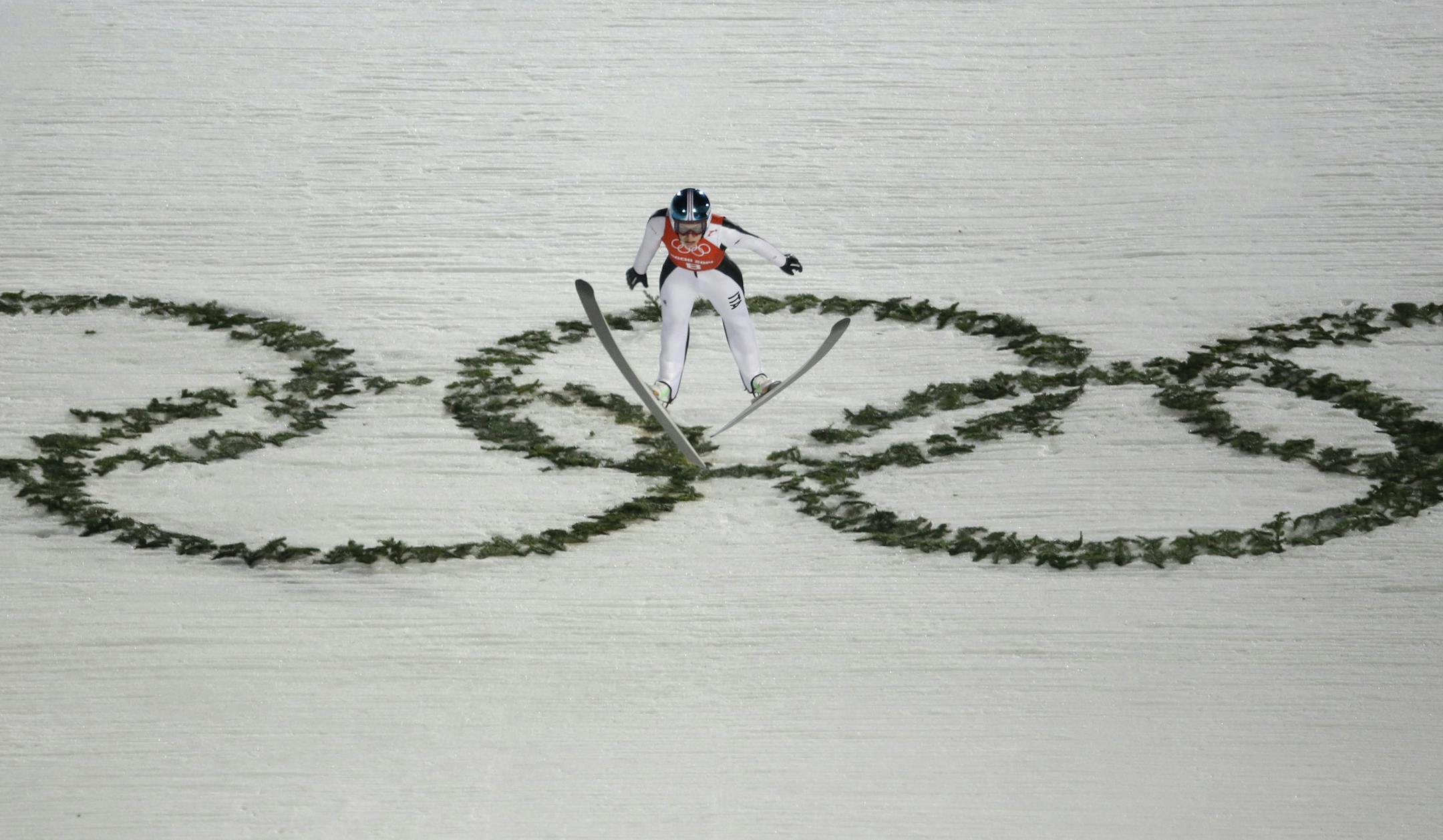 Italy's Evelyn Insam soared past the Olympic rings during a women's normal hill ski jumping training at the 2014 Winter Olympics on Monday.
