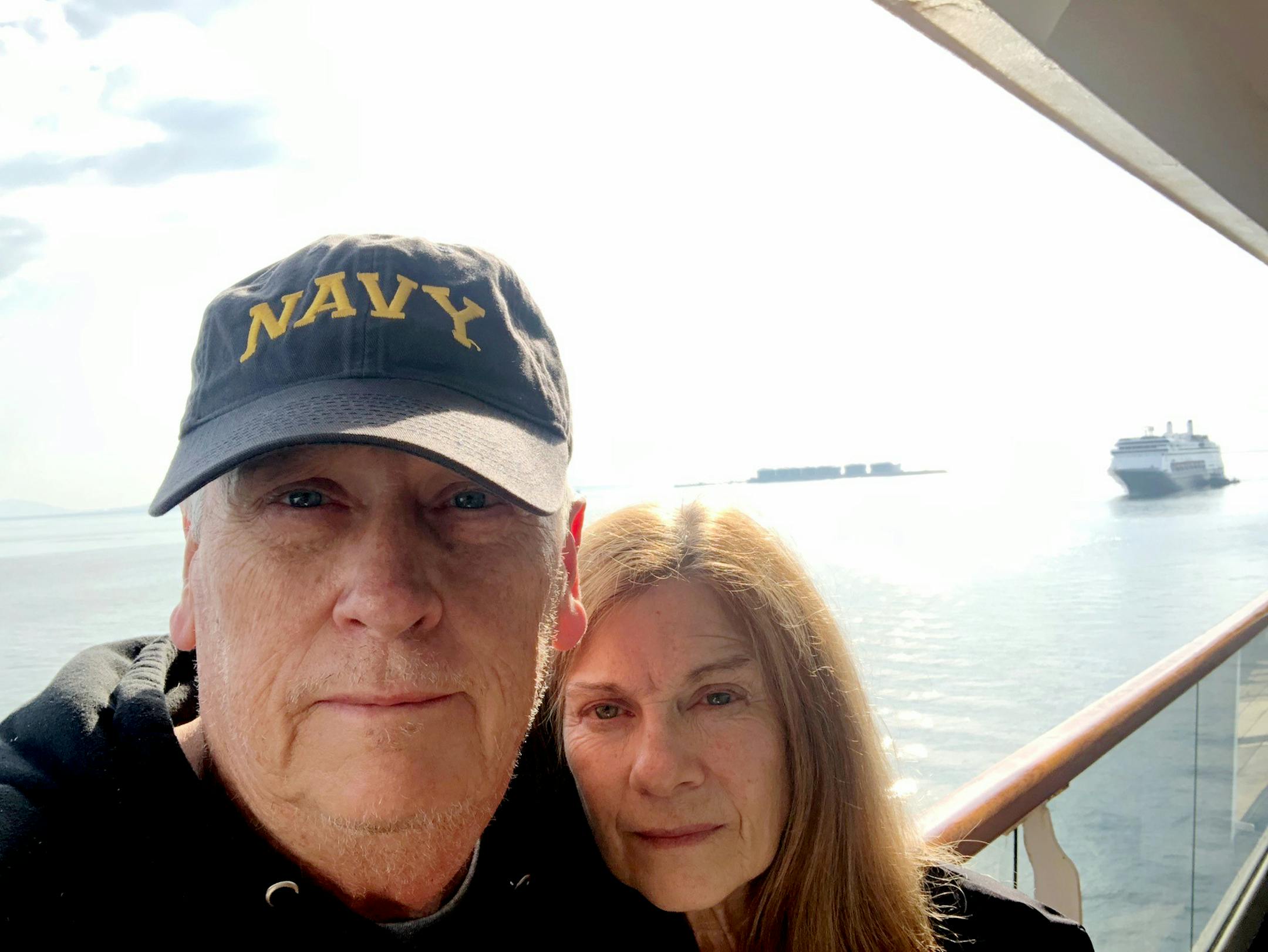 St. Cloud residents Andy Vinson, left, and Kathy Carton, right, are stuck on a cruise near the Panama Canal, as they await permission to return home on the Rotterdam cruise ship, seen floating nearby.