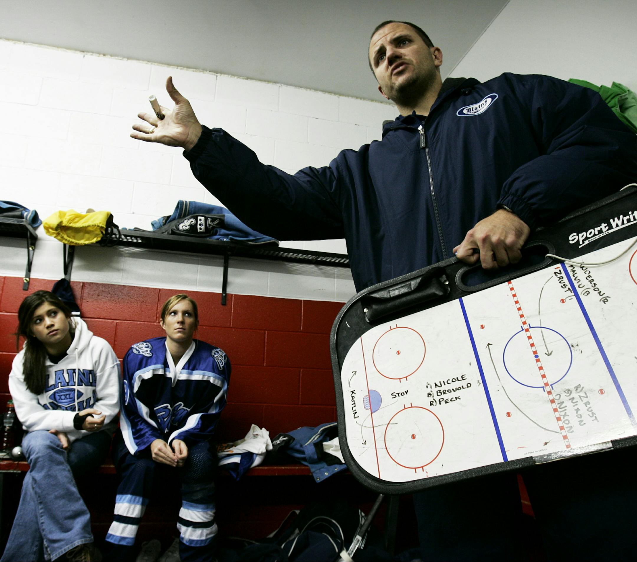 Blaine Bengals varsity girls hockey coach Steve Guider talks to his players in the locker room after the 1st period versus Elk River, Elk River, Minn., Dec. 21, 2004. Blaine defeated Elk River 3-1. (Ramin Rahimian/Star Tribune)
GENERAL INFORMATION: Story on Blaine girls hockey coach, Steve Guider. His father Mike died about one year ago in somewhat unexpected fashion. The team wears the initials "MG" on their helmets