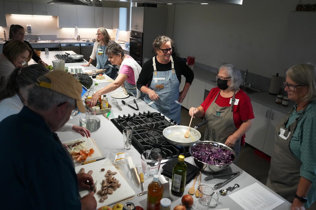 Chef Beth Fisher, center, the Arboretum’s culinary programmer and Instructor, talks with participants of her sold-out apple cooking class.
