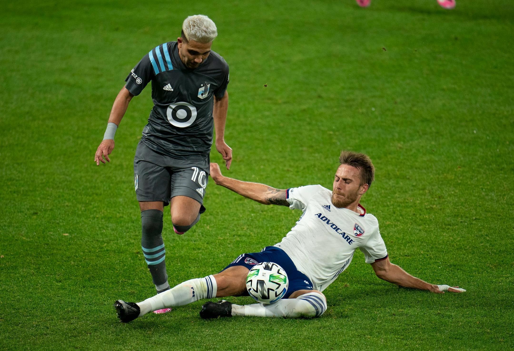 FC Dallas defender Bressan made a sliding tackle against Minnesota United midfielder Emanuel Reynoso last November at Allianz Field.