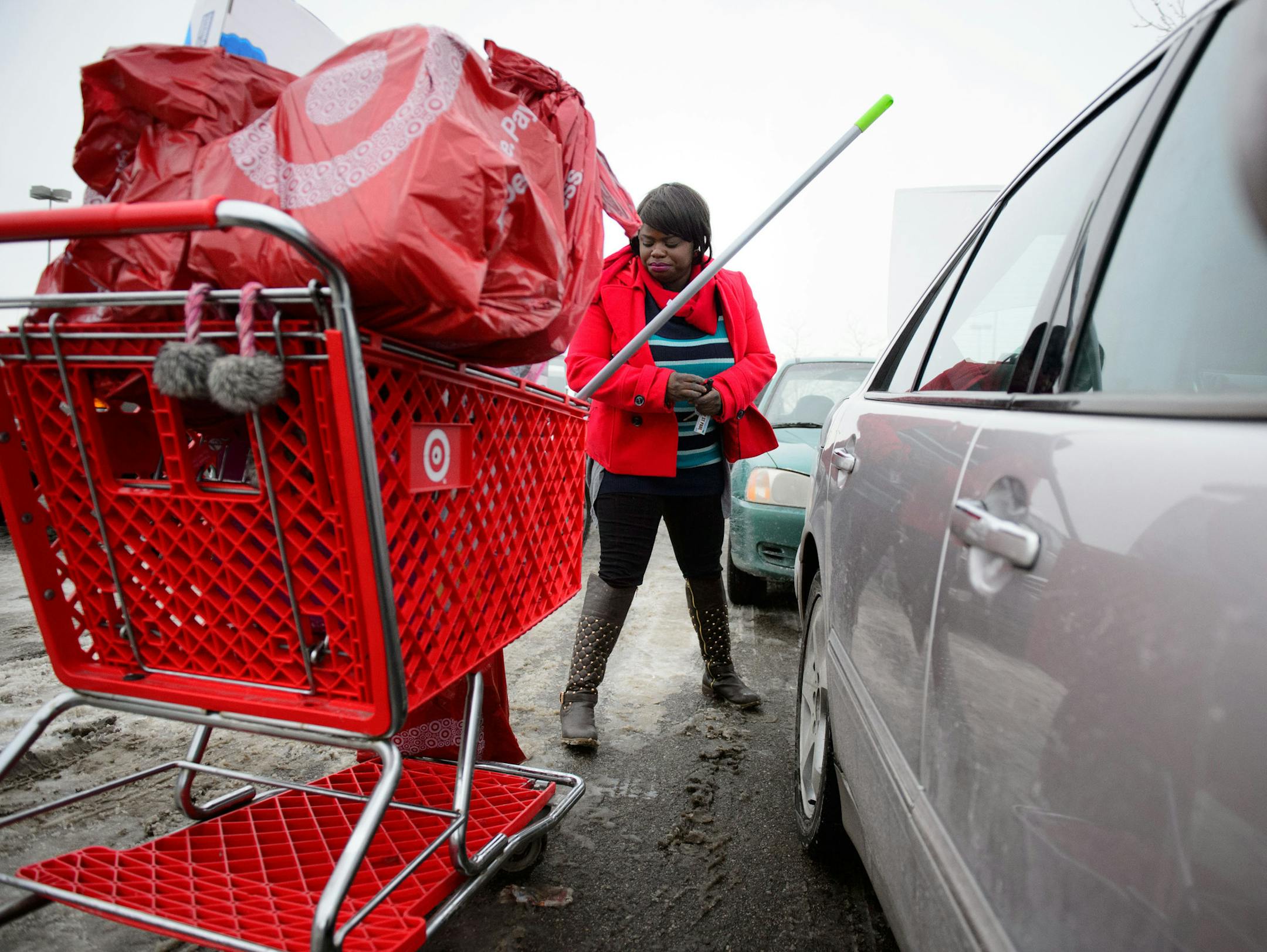 Janelle Borward loaded bags of supplies and gifts into her car after shopping the Midway Target store in St. Paul. Thursday, December 19, 2013. ] GLEN STUBBE * gstubbe@startribune.com