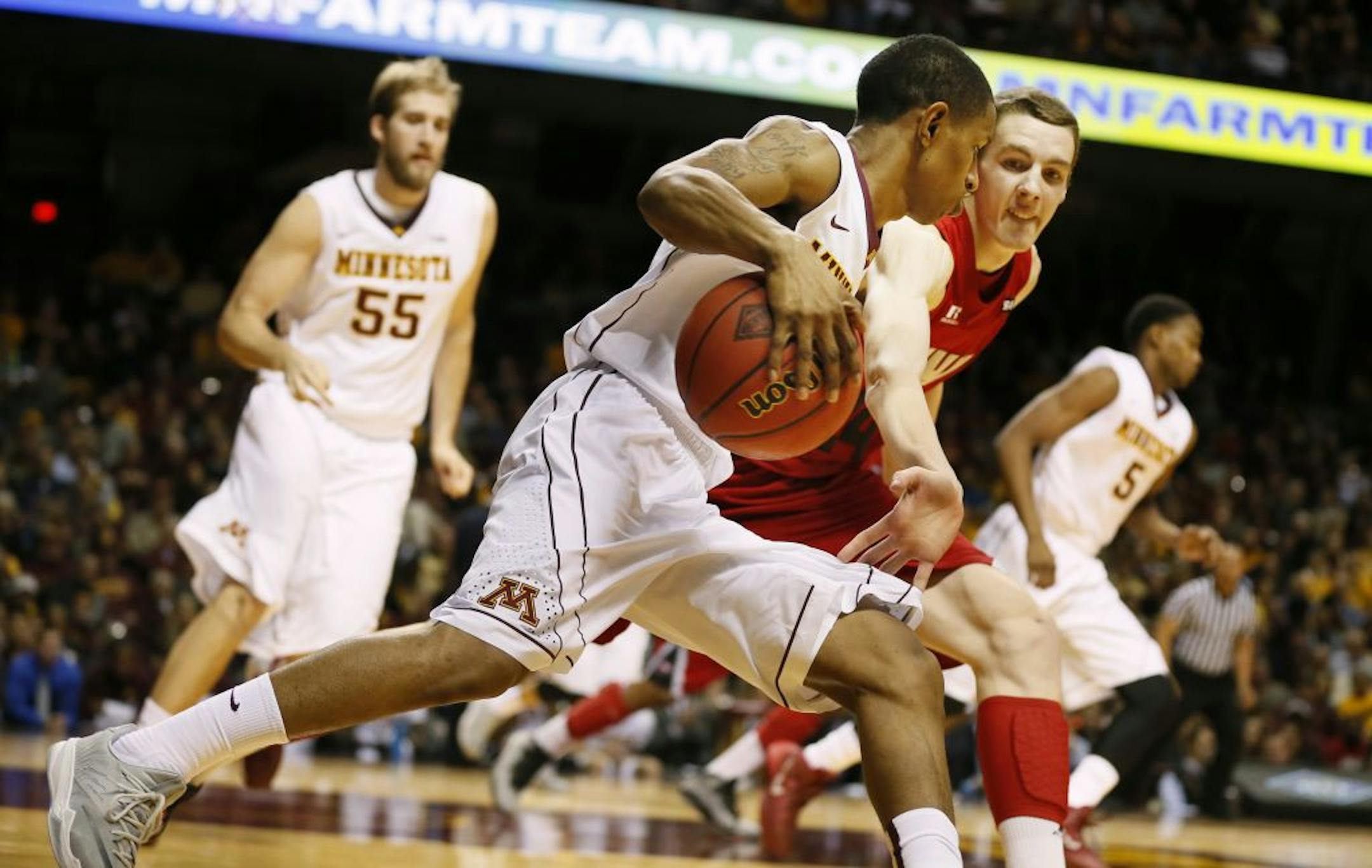 Gophers guard DeAndre Mathieu dribbled passed Western Kentucky forward Ben Lawson during Minnesota's 76-54 victory Tuesday at Williams Arena.