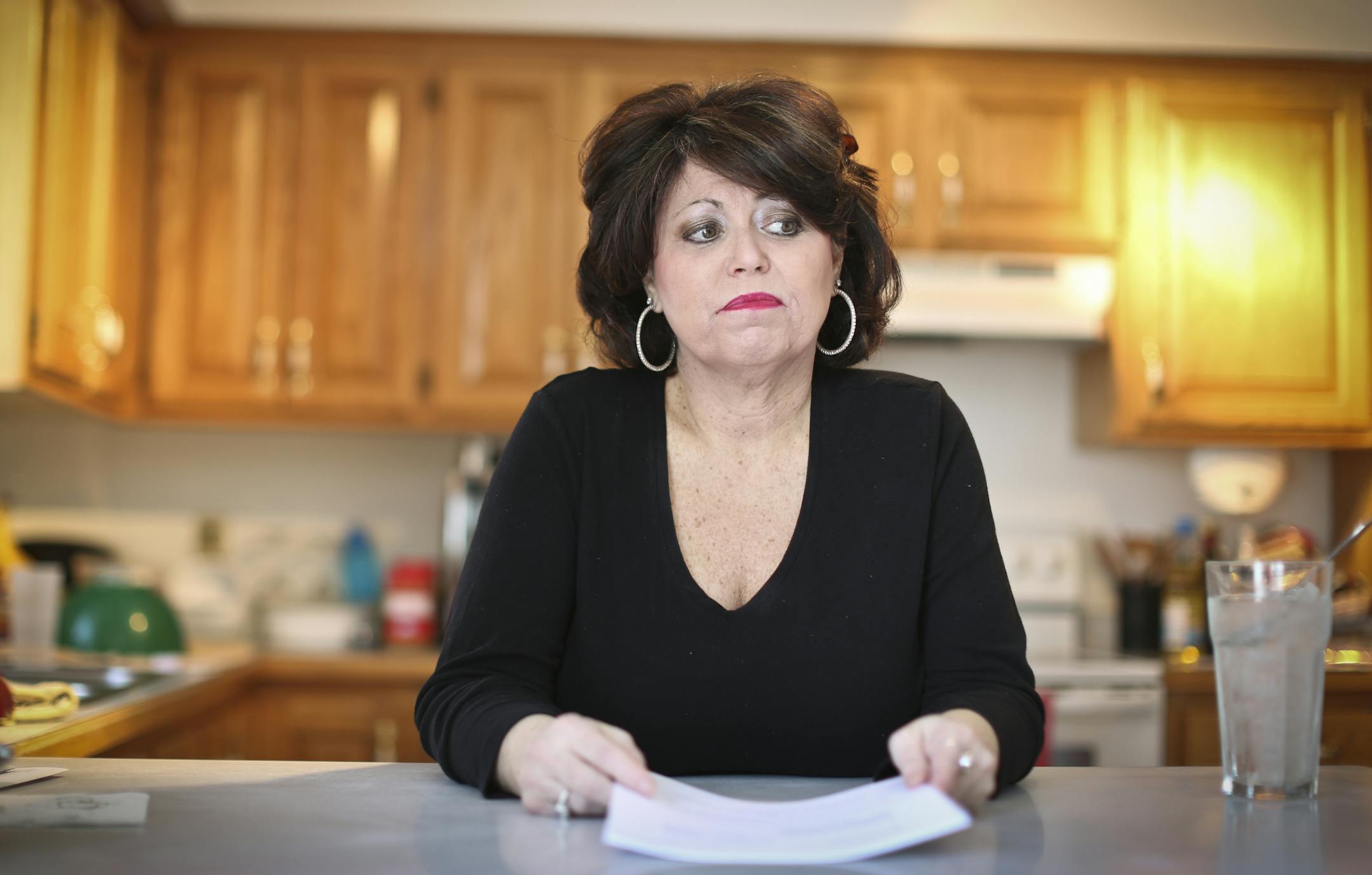 Melony Micheals held the papers that declared a judgement of $800,000 in damages against the mortgage fraudsters (who stole her and her husband's identities) from a civil trial that ended this week. Even though they may never see the money, she feels good that this judgement may be the first of its kind to recognize losses in terms of identity theft and mortgage fraud, and may be able to help others. She was at her home on Wednesday, March 6, 2013, in Plymouth, Minn. ] (RENEE JONES SCHNEIDER * r