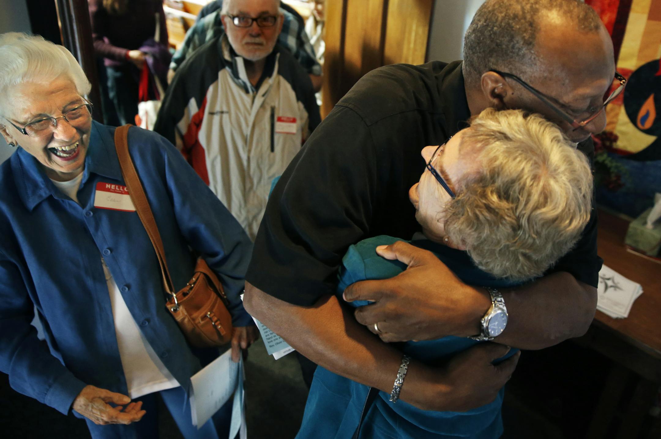 At Clark Memorial Church in South St. Paul, the Rev. Oliver White, the St. Paul pastor who lost most of his congregation at Grace Community Church after he came out in favor of gay marriage, hugged Jane Tereau as friend Ellen Duncanson, 88, smiled and watched.]richard tsong-taatarii/rtsong-taataarii@startribune.com ORG XMIT: MIN1309221618471796