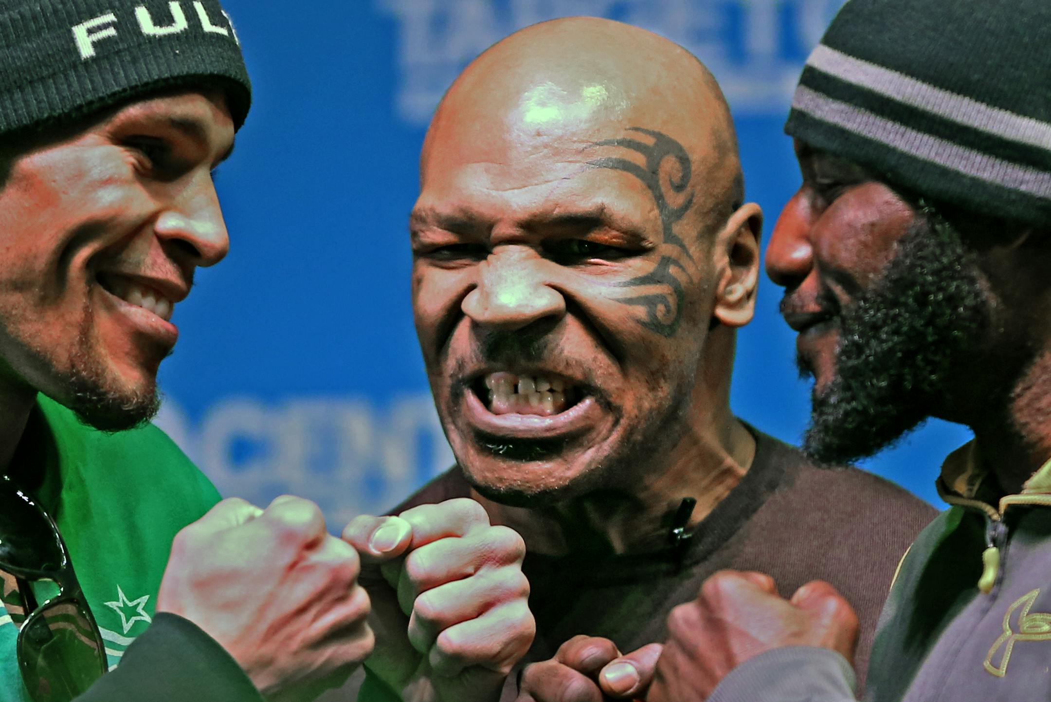 (center) Former Heavyweight Champion Mike Tyson stood between middleweight fighters (left) Caleb Truax of Osseo MN and Ossie Duran of Paterson NJ during the end of the press conference for ESPN Friday Nights Fights at the Target Center. The event took place at the Pourhouse in downtown Minneapolis on 1/2/14.] Bruce Bisping/Star Tribune bbisping@startribune.com Mike Tyson, Caleb Traux, Ossie Duran/roster.