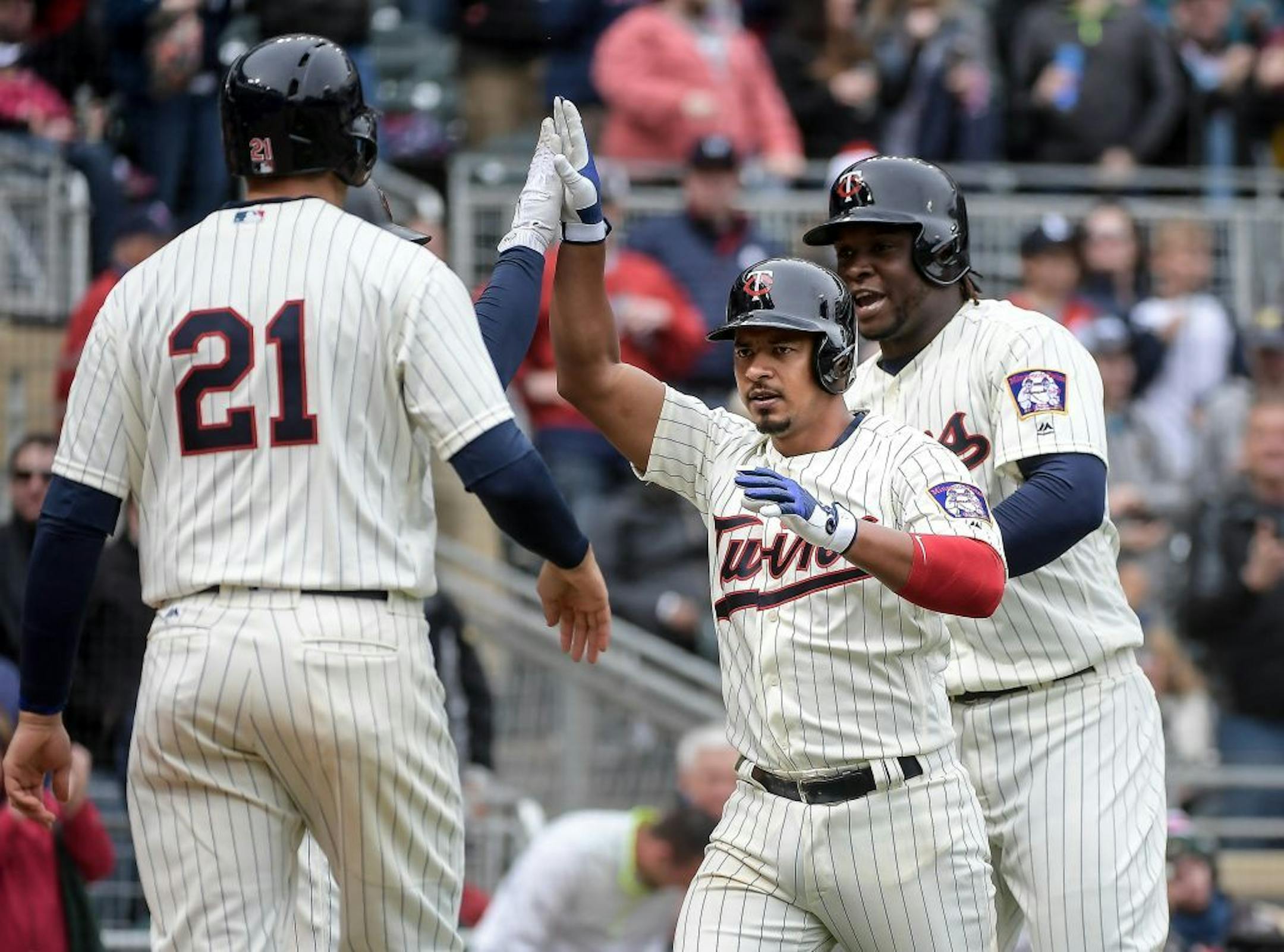 Minnesota Twins shortstop Eduardo Escobar (5) celebrated with teammates, including Minnesota Twins catcher Jason Castro (21)and third baseman Miguel Sano (22) after Escobar hit a 3-run homer in the bottom of the seventh inning against the Kansas City Royals.