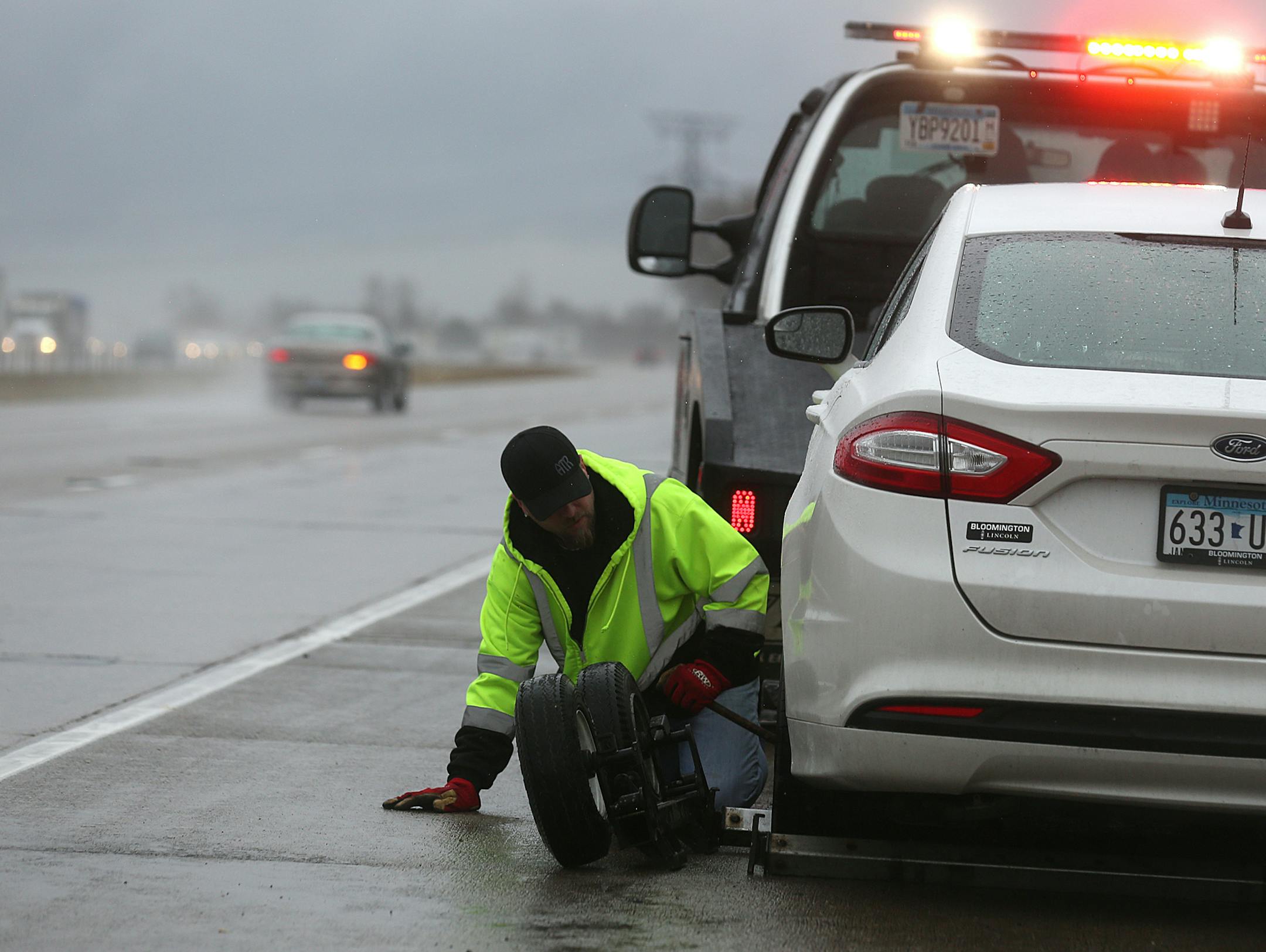 Tim Heldman prepared to tow a car along Interstate 94. Earlier this year, one of his drivers lept over a median on I-94 to avoid an oncoming vehicle, only to be hit by two cars on the other side.
