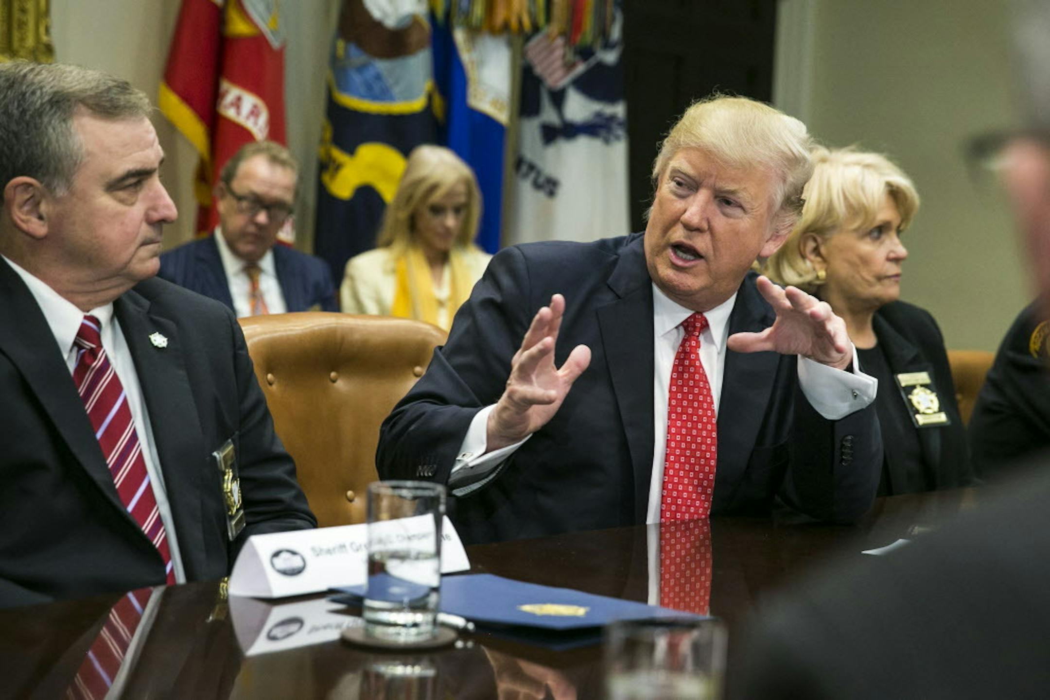 President Donald Trump meets with a group of sheriffs in the Roosevelt Room of the White House in Washington, Feb. 7, 2017. At left is St. Charles, La. Parish Sheriff Greg Champagne, the president of the National Sheriffs Association, and at right is Sheriff Carolyn Welsh, from Chester County, Pa.