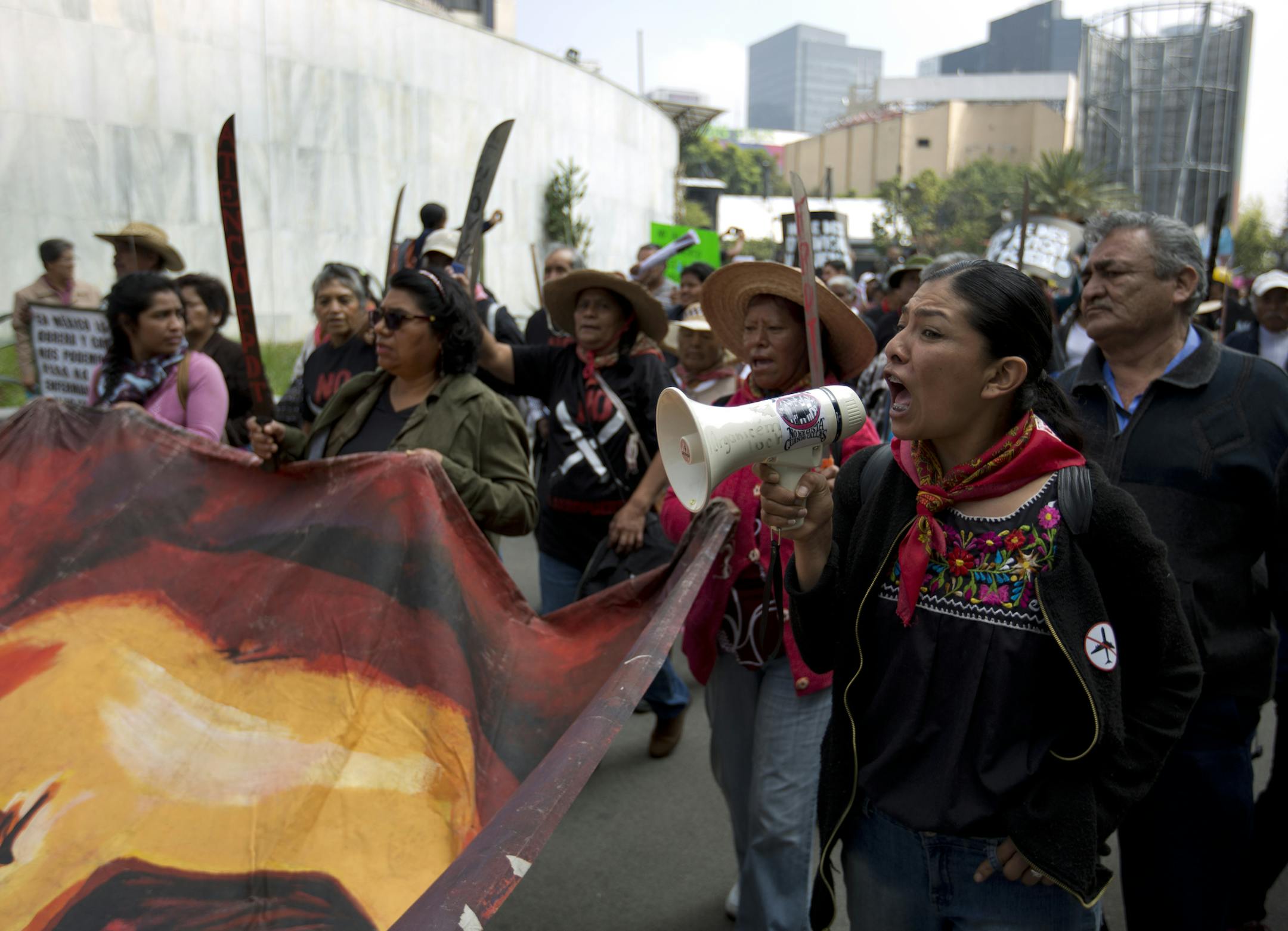 A woman shout slogans during a march to the headquarters of Mexico's President-elect Andres Manuel Lopez Obrador to deliver a letter, in Mexico City, Tuesday, Aug. 14, 2018. Residents of Atenco arrived to deliver a letter to Lopez Obrador to ask him to stop the construction of a new Mexico City airport. (AP Photo/Eduardo Verdugo) ORG XMIT: MXEV102