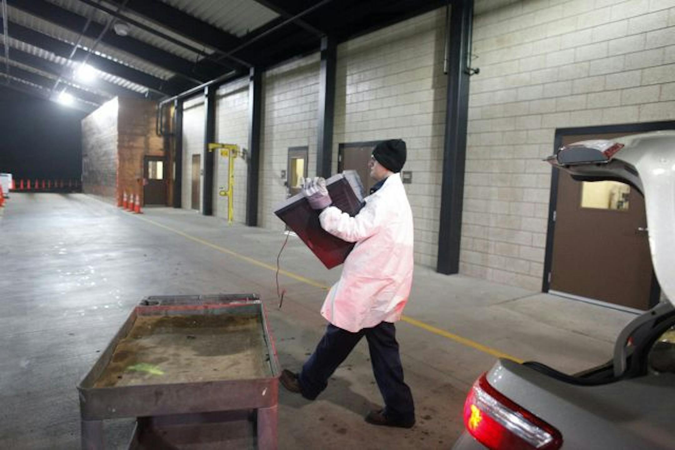 Jason Leoni, an employee at the Washington County environmental center, took an old television from a Woodbury resident's car Tuesday and sent it off to its final reward.