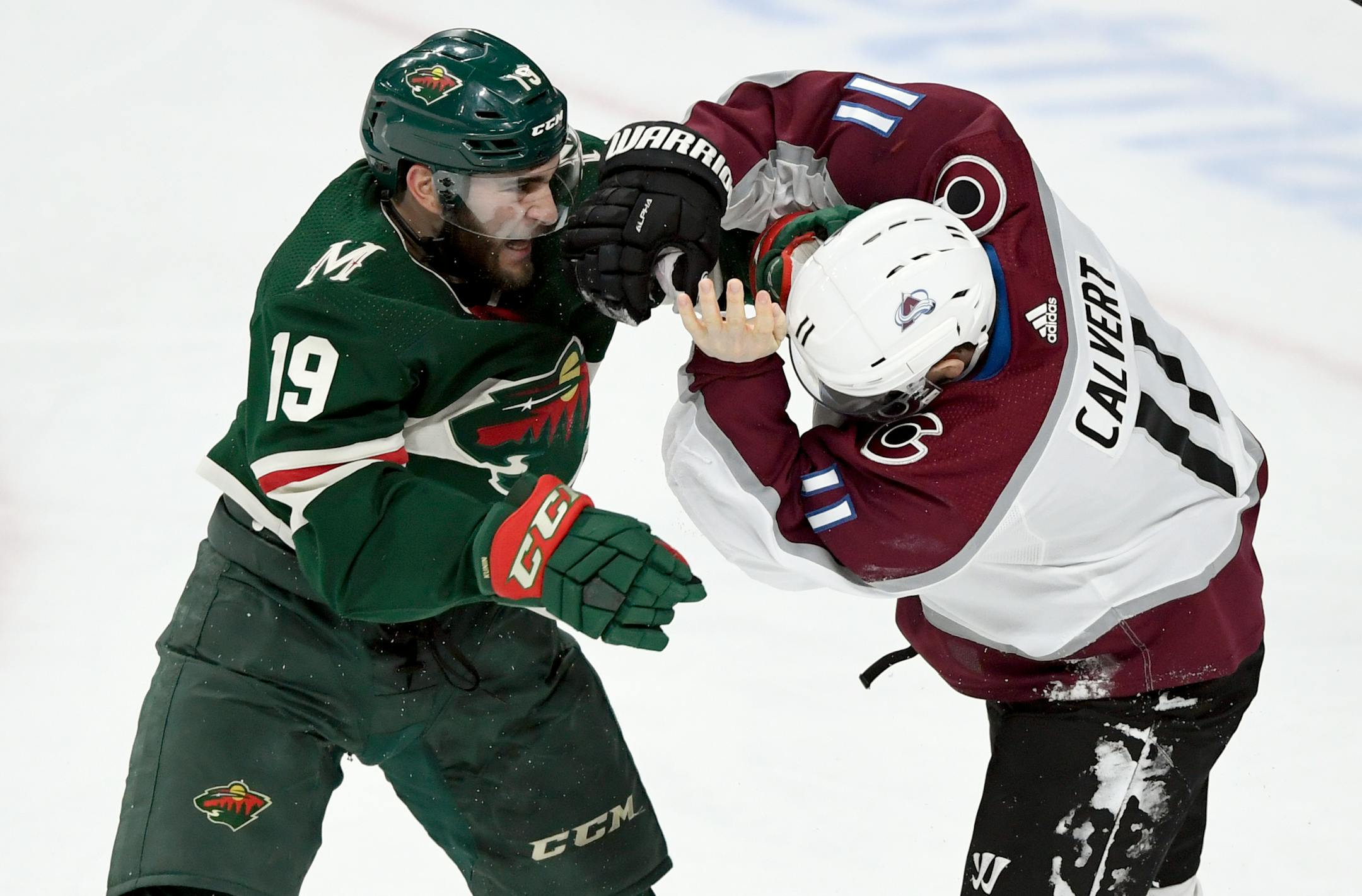 Minnesota Wild center Luke Kunin (19) and Colorado Avalanche left wing Matt Calvert (11) fight during the third period of an NHL hockey game Sunday, Feb. 9, 2020, in St. Paul, Minn. Both players received penalties. The Avalanche won 3-2. (AP Photo/Hannah Foslien)