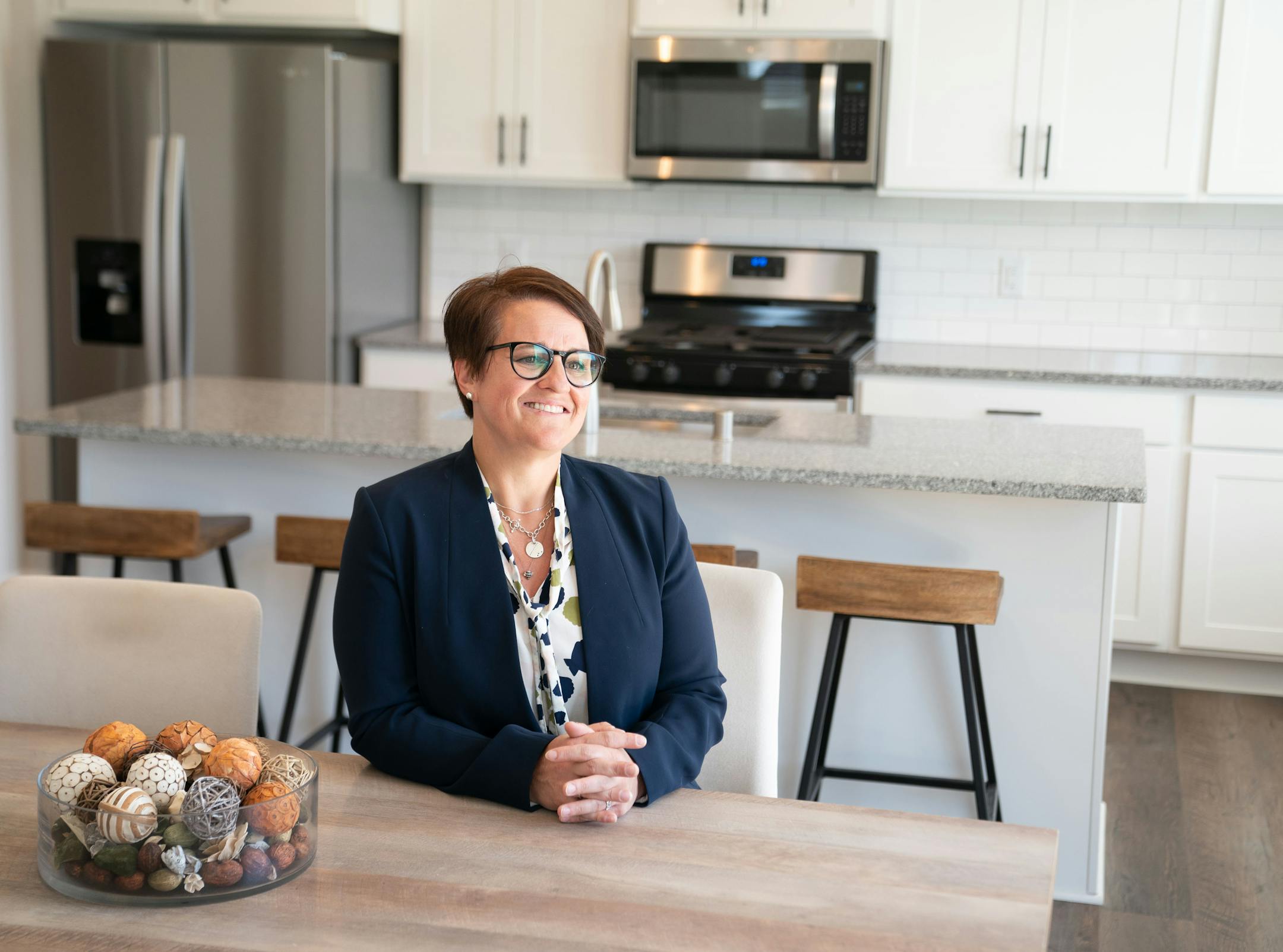 Nikki Longie, regional property manager with Lincoln Property Company, posed for a portrait in a model home at Canvas at Woodbury.