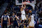 Timberwolves center Rudy Gobert dunks against Pelicans guard Trey Murphy III during the first half Wednesday