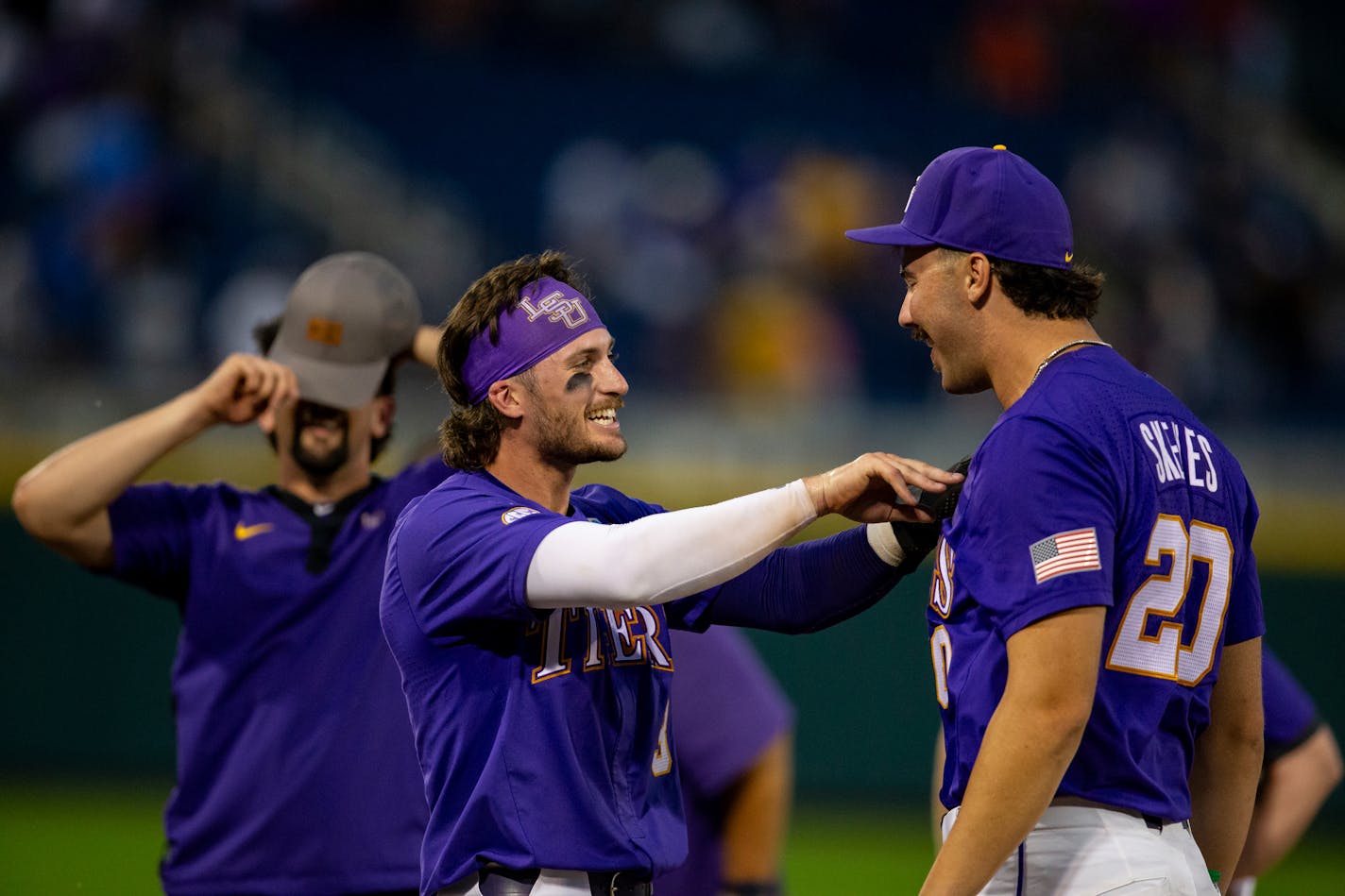 LSU Dylan Crews (3) celebrates with Paul Skenes (20) the win over Wake Forest in a baseball game at the NCAA College World Series in Omaha, Neb., Thursday, June 22, 2023. (AP Photo/John Peterson)