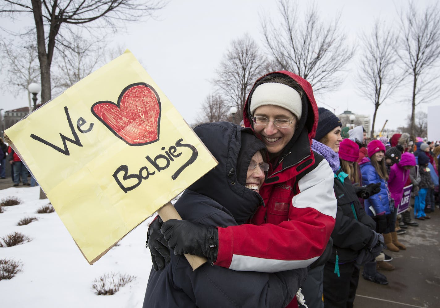 Caileen Kromhout, right, of St. Paul gets a hug from her godmother Alice Olson of Forrest Lake during the annual Minnesota Citizens Concerned for Life March for Life at the State Capitol Mall in St. Paul on Friday, January 22, 2016. ] (Leila Navidi/Star Tribune) leila.navidi@startribune.com