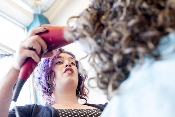 Co-owner Rosie Jablonsky works on a client's hair to show her how great her curls can look at Uptown Curl in Minneapolis October 24, 2014.
