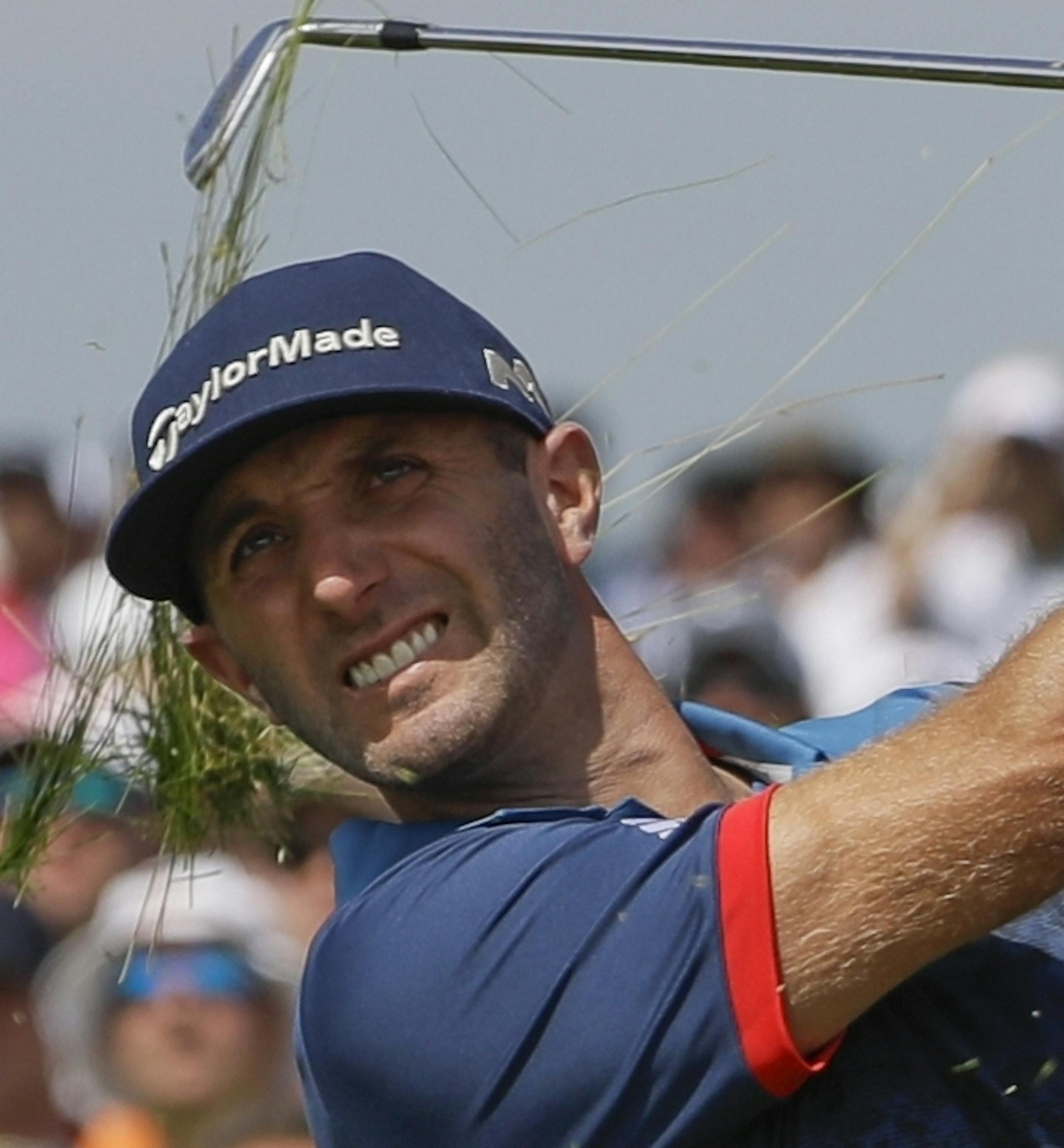 Dustin Johnson hits out of the fescue on the 17th hole during the first round of the U.S. Open golf tournament Thursday, June 15, 2017, at Erin Hills in Erin, Wis. (AP Photo/David J. Phillip)