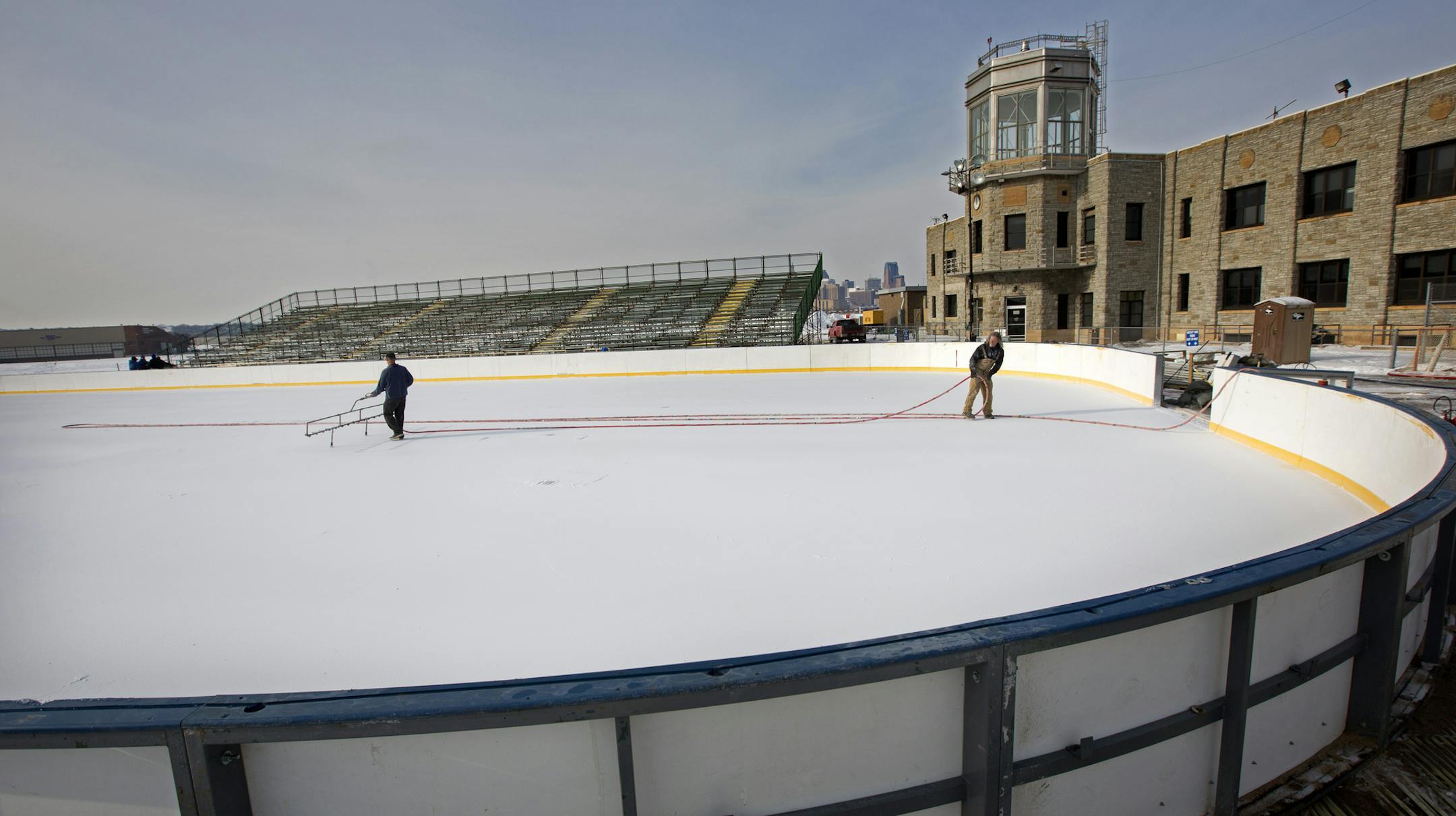 Crews put the final touches on the hockey rink at Holman Field in St. Paul that will feature three high school hockey games as part of Hockey Day Minnesota Saturday Jan. 17. The games will be beamed across the globe to Minnesota National Guard members in the Middle East. ] BRIAN PETERSON ‚Ä¢ brianp@startribune.com St. Paul, MN - 12/14/2012