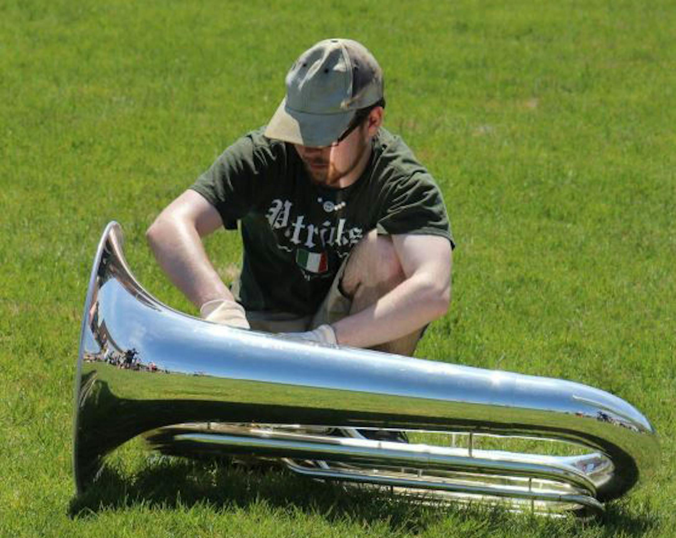 Robert Cooley tends to his tuba during a Minnesota Brass rehearsal in mid-June.