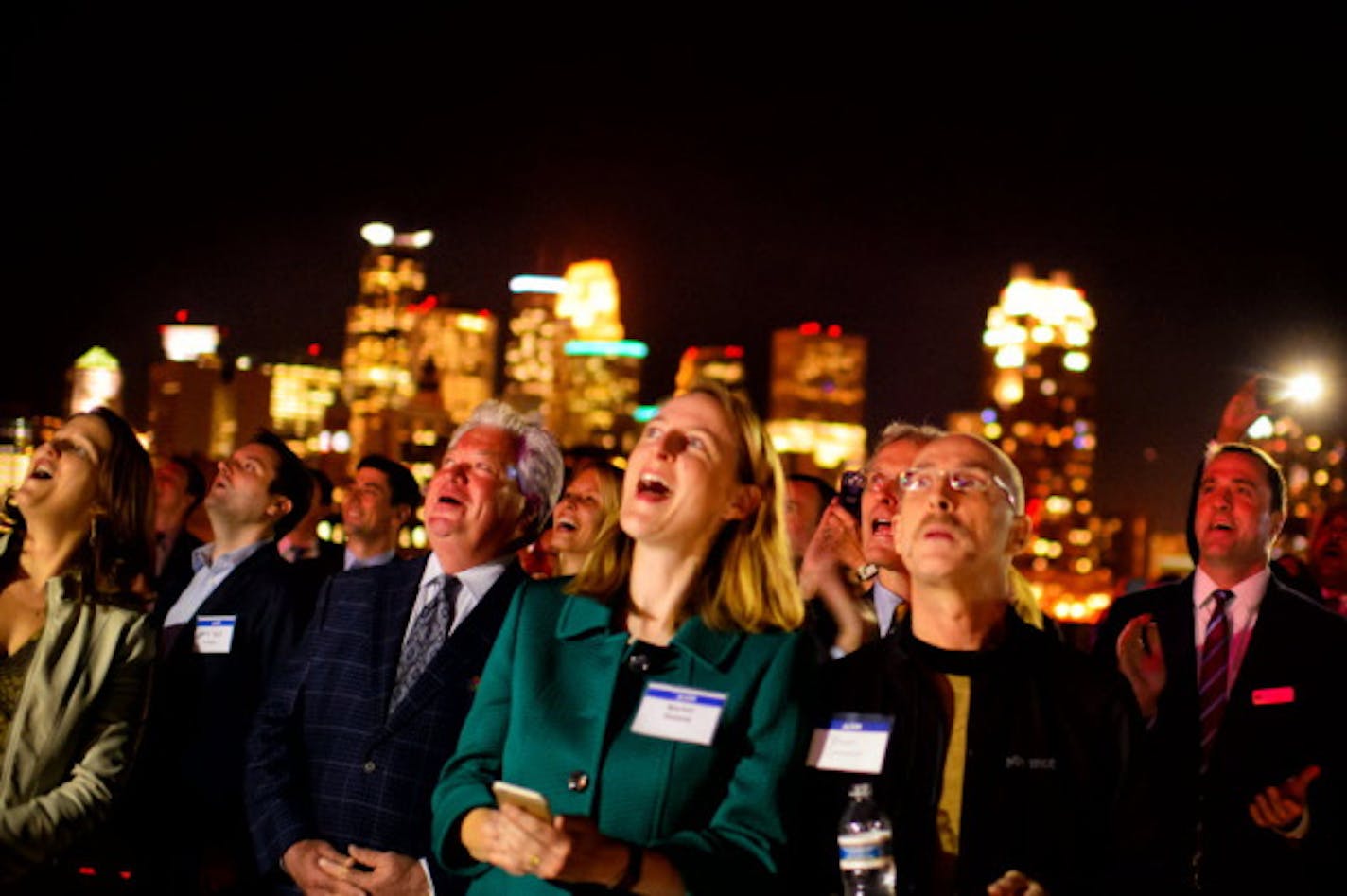 Onlookers celebrate from the roof of the old mill complex. Star Tribune Staff Photo by Glen Stubbe