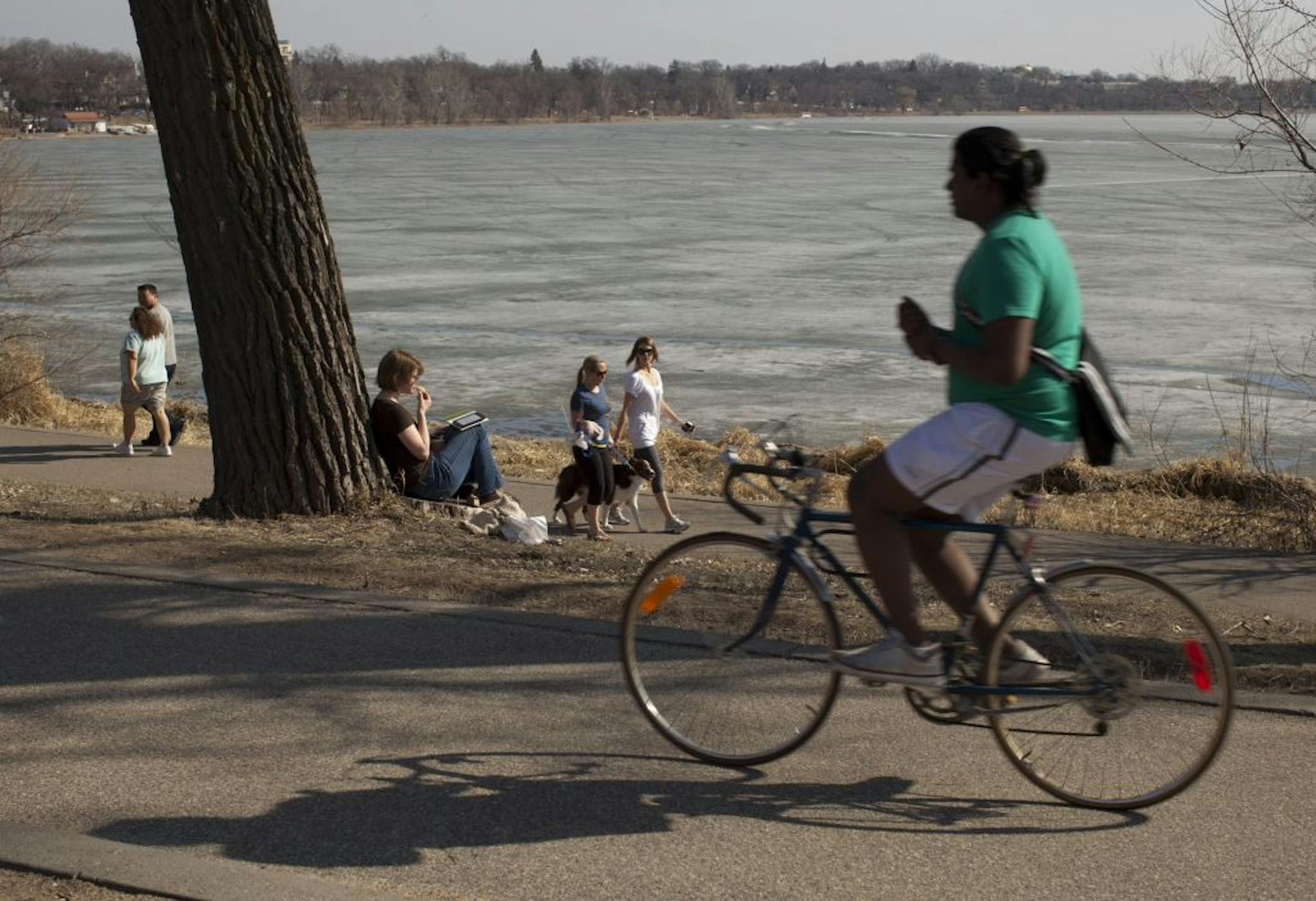 Unseasonably warm weather beckoned people outside on March 14 at Lake Calhoun in Minneapolis. But the balmy season chilled bottom lines at Xcel Energy Inc. and other U.S. utilities.