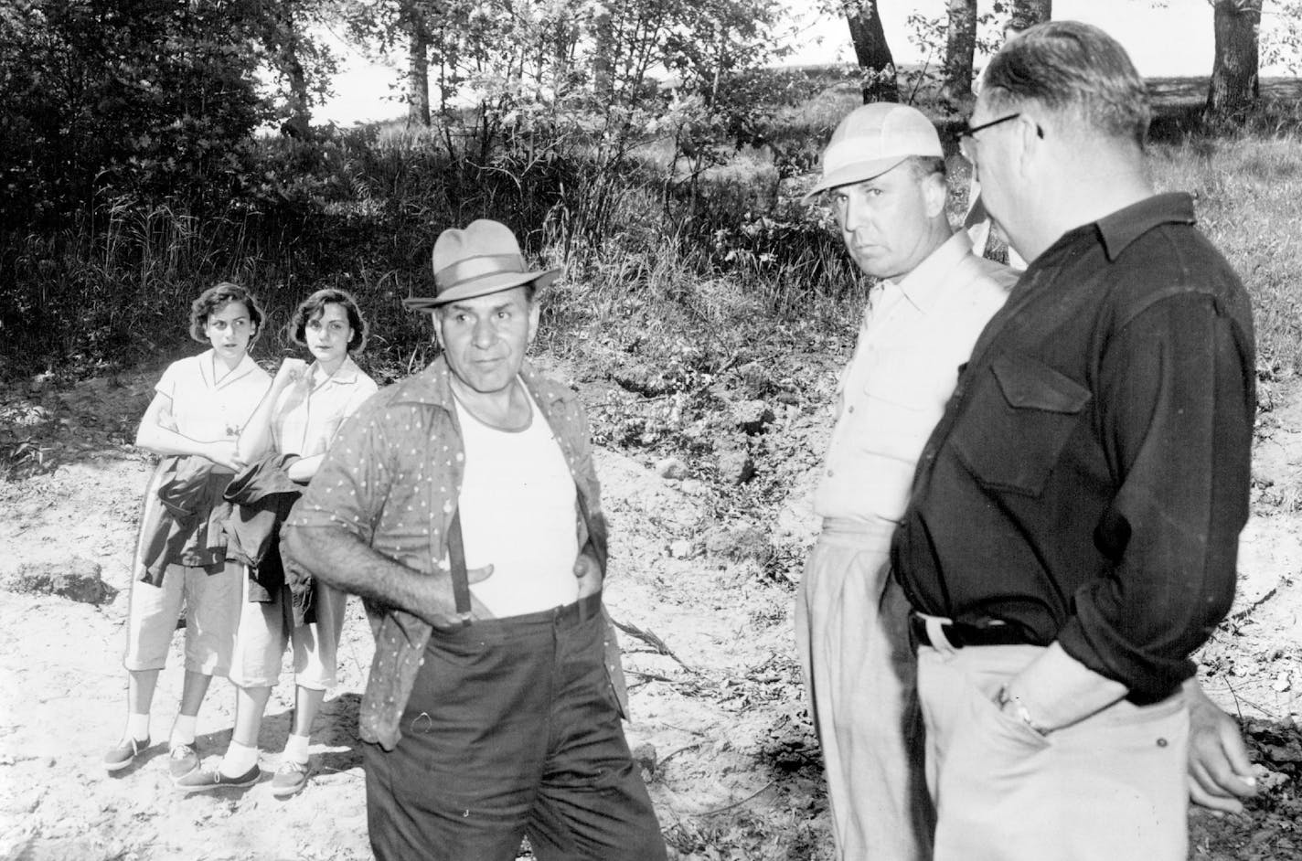 May 13, 1955 Sam DeVito, 59, 577 Brunson street, St. Paul, and daughters, Phyliss (left) and Patricia, 15 - year - old twins, watched Thursday as authorities made an unsuccessful search to find the grave of Tony DeVito, missing since Sept. 27, 1953, and and believed slain by gangsters.