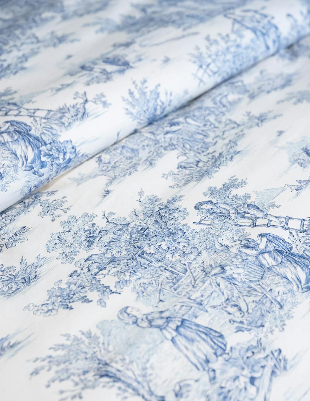 Toile fabric, with its classic motifs and elegant charm, has made a resurgence in new traditional home decor. 