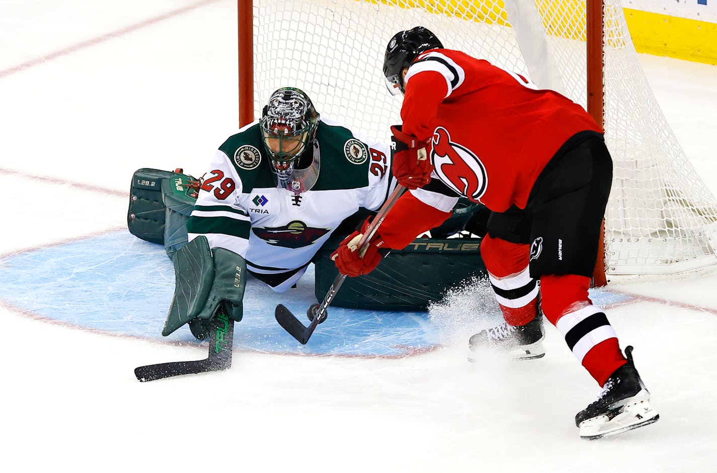 Minnesota Wild goaltender Marc-Andre Fleury (29) makes a save against New Jersey Devils center Curtis Lazar during the third period of an NHL hockey game, Sunday, Oct. 29, 2023, in Newark, N.J. (AP Photo/Noah K. Murray)