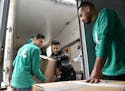 Volunteers unloaded books at the University of Mosul Nov. 25. The academic topics included medicine, engineering, law and IT.