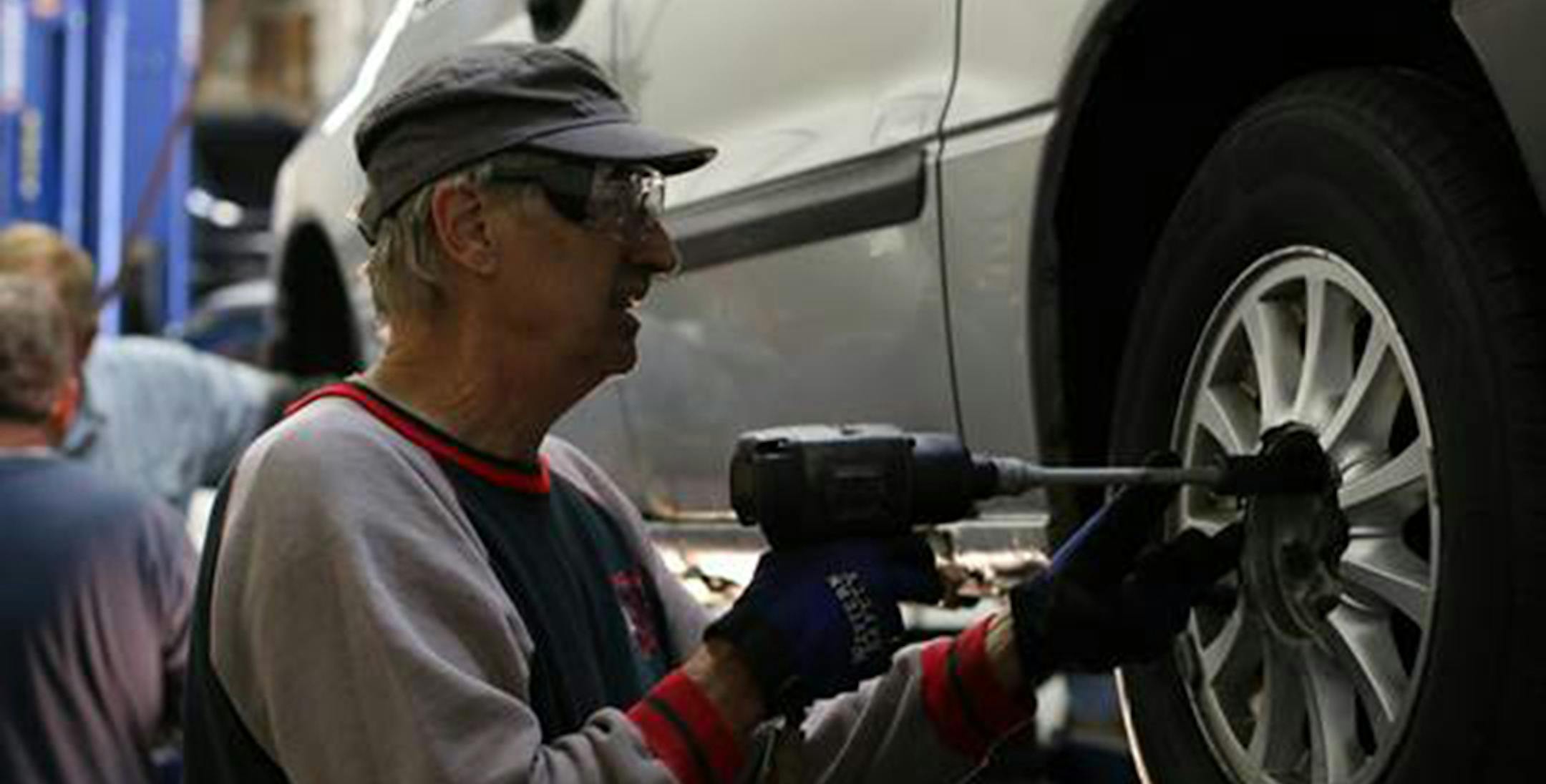 Cars for Neighbors Board member, Richard Krusemark, works on a vehicle to be given to a family in need during Car Care Saturday (Oct. 4).