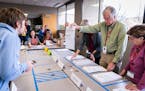 Ramsey County election judge Rick Winters showed a ballot to an observer during the sorting process of the Ward One St. Paul City Council race ballots