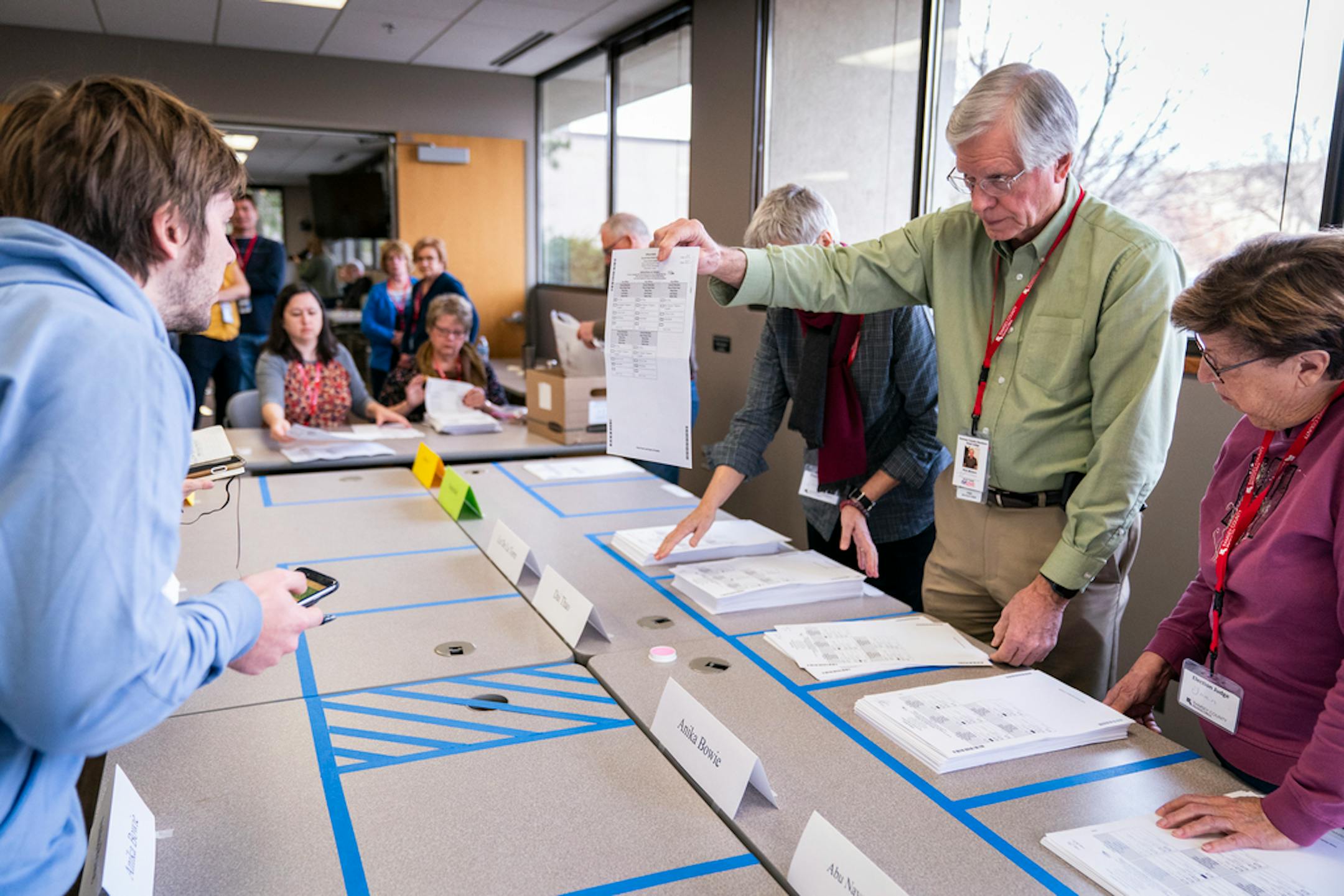 Ramsey County election judge Rick Winters showed a ballot to an observer during the sorting process of the Ward One St. Paul City Council race ballots at the Ramsey County Elections office in St. Paul on Friday, November 8, 2019.