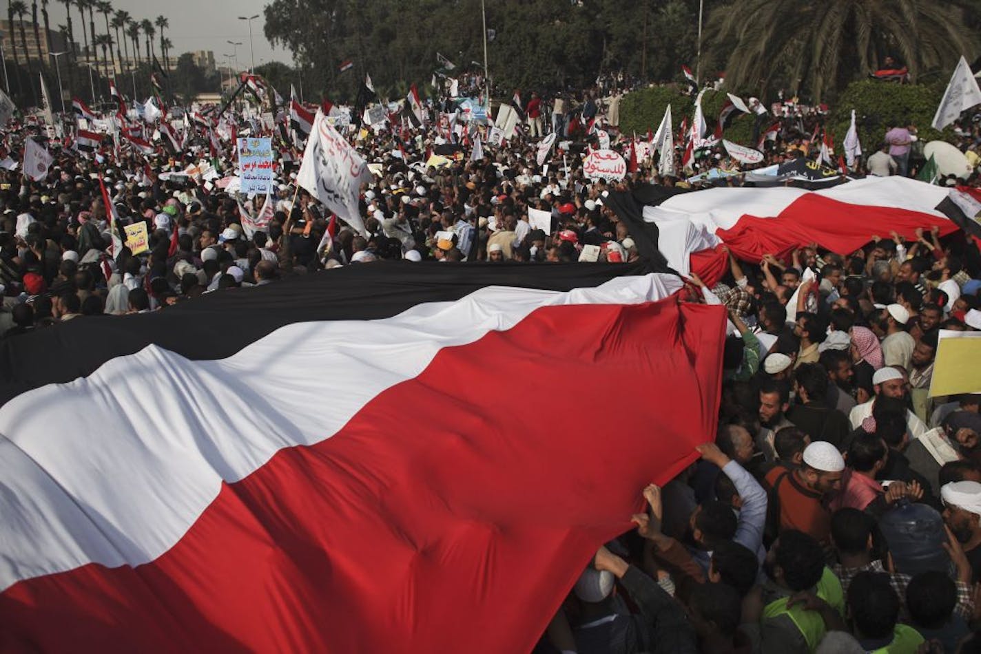 Supporters of Egyptian President Mohammed Morsi stage a demonstration in Cairo, Dec. 1, 2012. While the governing Islamists say the old guard has infiltrated the opposition, critics of Morsi hear a familiar paranoia in his efforts to take more control.