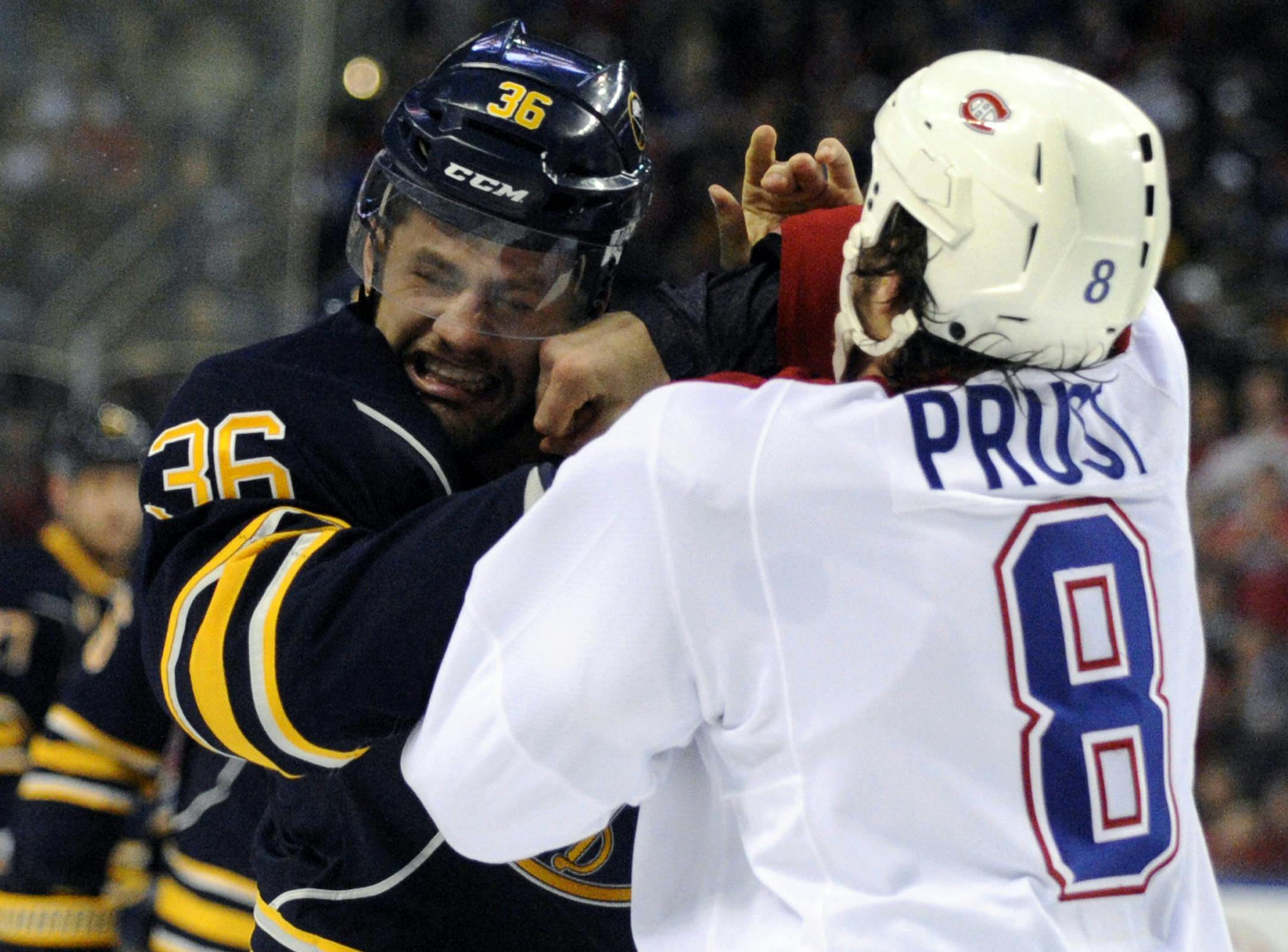 Buffalo Sabres' right winger Patrick Kaleta (36) is punched by Montreal Canadiens' left winger Brandon Prust (8) during a fight in the first period of an NHL hockey game in Buffalo, N.Y., Thursday, April 11, 2013. (AP Photo/Gary Wiepert) ORG XMIT: NYGW101
