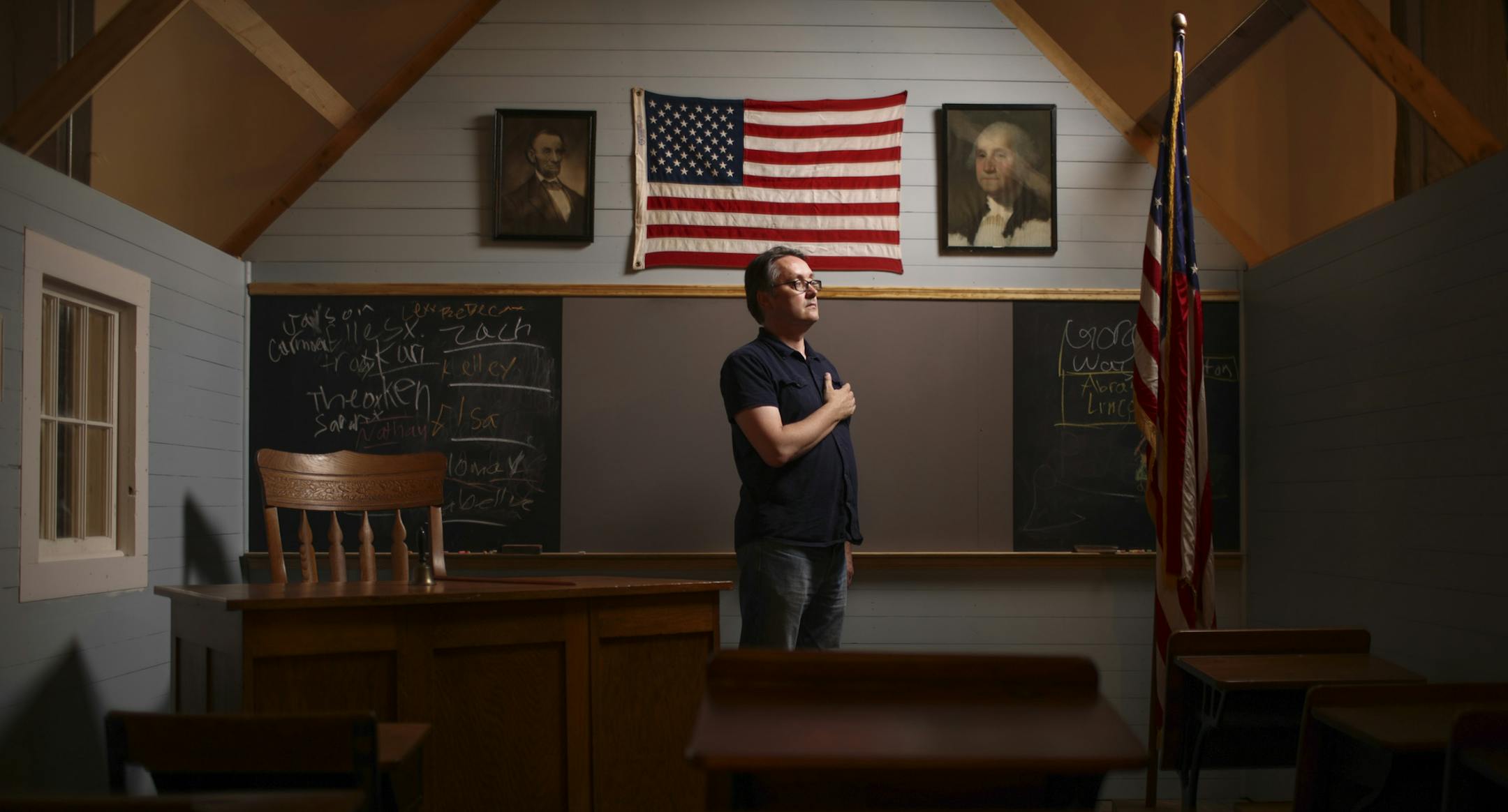 Ben Heywood in the installation "Pledge Project" at The Soap Factory Monday afternoon. The piece, by artists Shana Berger and Nathan Purath, explores the ritual of the Pledge of Allegiance. They recreated a one room schoolhouse based on the historic Perault School near Red Lake Falls, which Purath's grandfather attended in the 1920's. ] JEFF WHEELER ‚Ä¢ jeff.wheeler@startribune.com The Soap Factory's Executive Director Ben Heywood is donning a curator's hat for "Americana," a lo