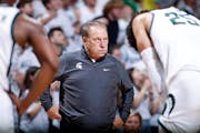 Michigan State coach Tom Izzo, center, Malik Hall, right, and Tyson Walker react during overtime against James Madison during an NCAA college basketba