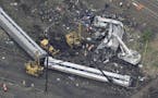 In this aerial photo, emergency personnel work at the scene of a deadly train wreck, Wednesday, May 13, 2015, in Philadelphia.