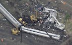 In this aerial photo, emergency personnel work at the scene of a deadly train wreck, Wednesday, May 13, 2015, in Philadelphia.