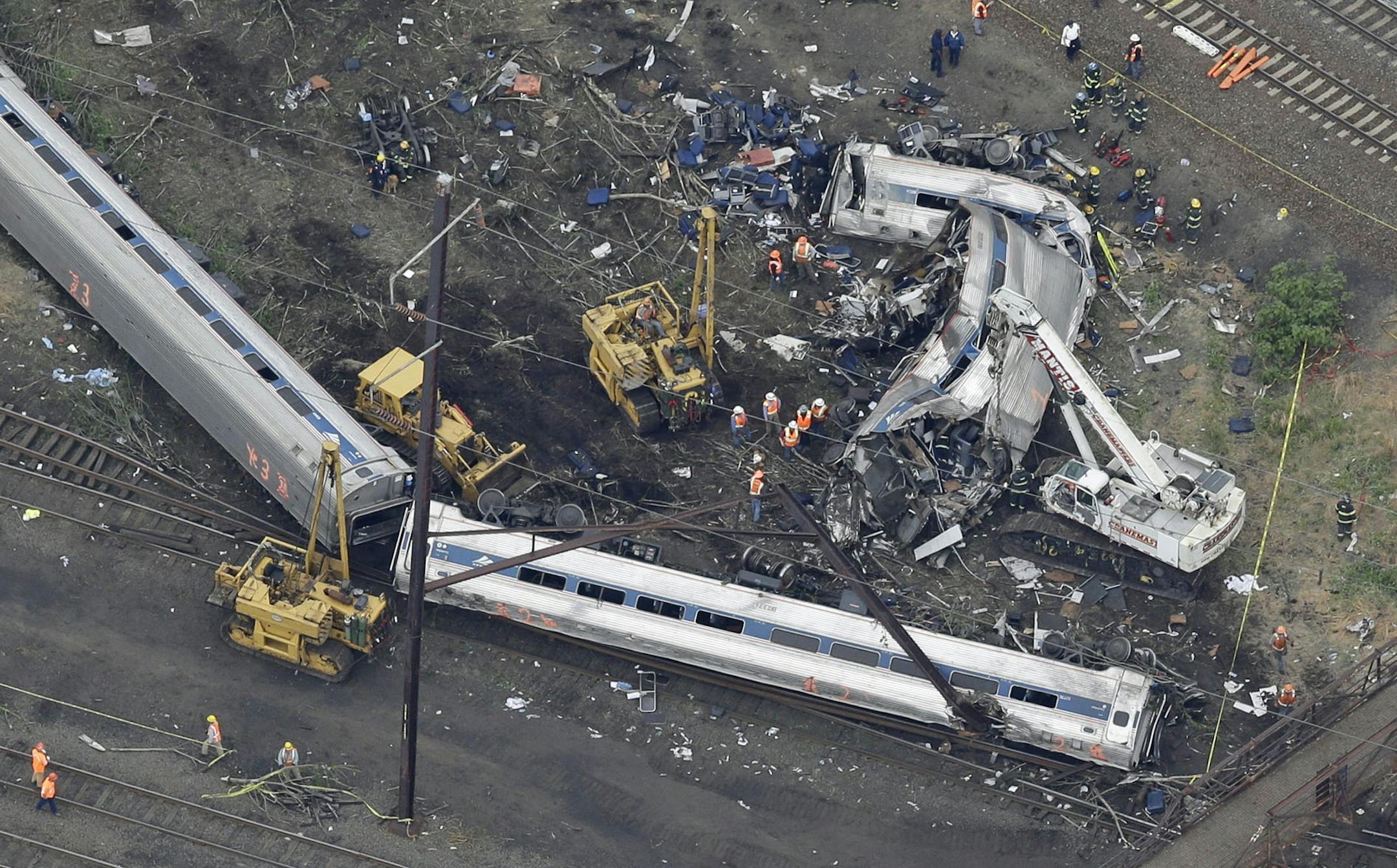 In this aerial photo, emergency personnel work at the scene of a deadly train wreck, Wednesday, May 13, 2015, in Philadelphia.