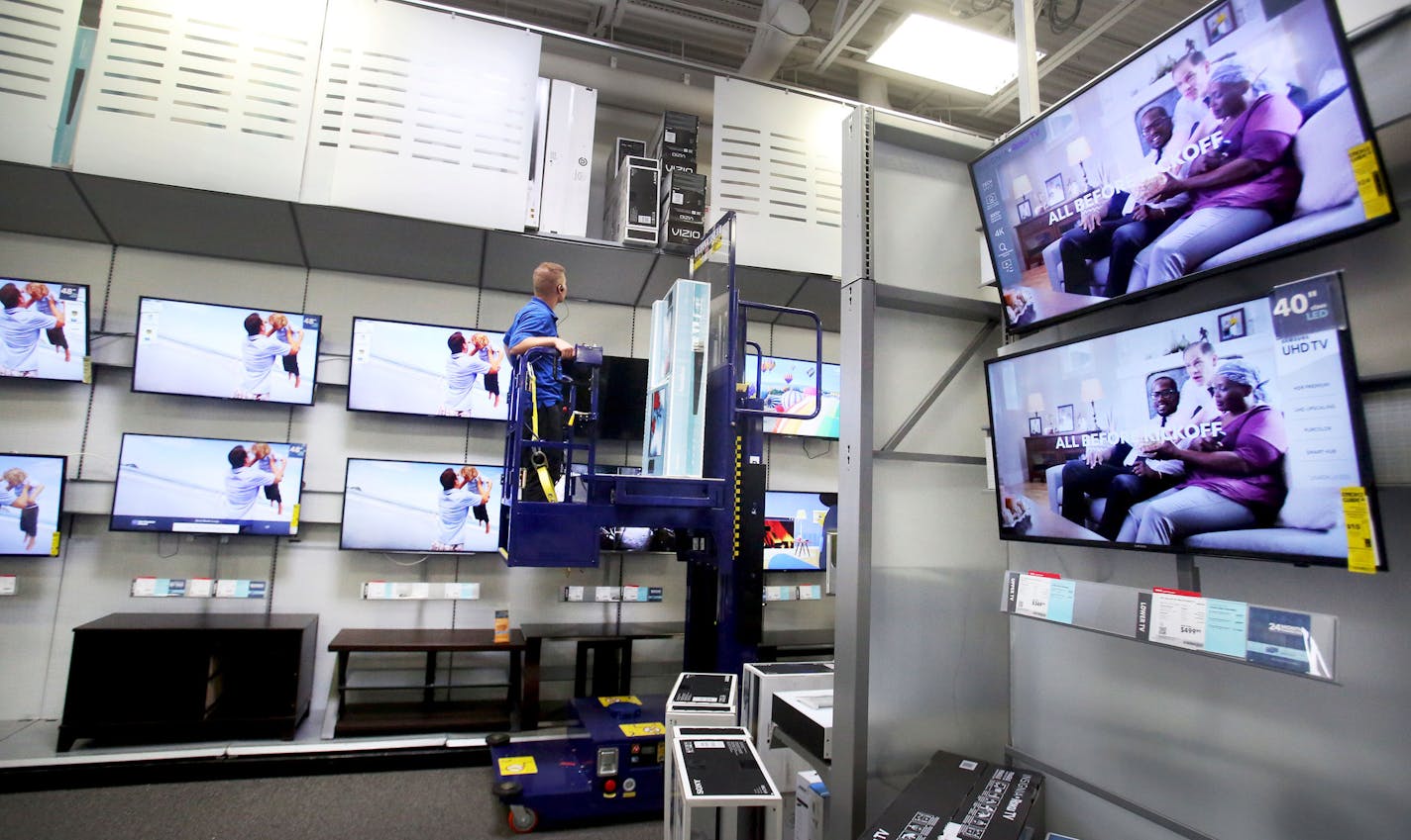 Best Buy employee Kyle Arola stocked new TVs at a Best Buy store Tuesday, Aug. 23, 2016, in Eden Prairie, MN.](DAVID JOLES/STARTRIBUNE)djoles@startribune Second quarter earnings reports were in Tuesday and Best Buy exceeded expectations.**Woody Nelson,cq