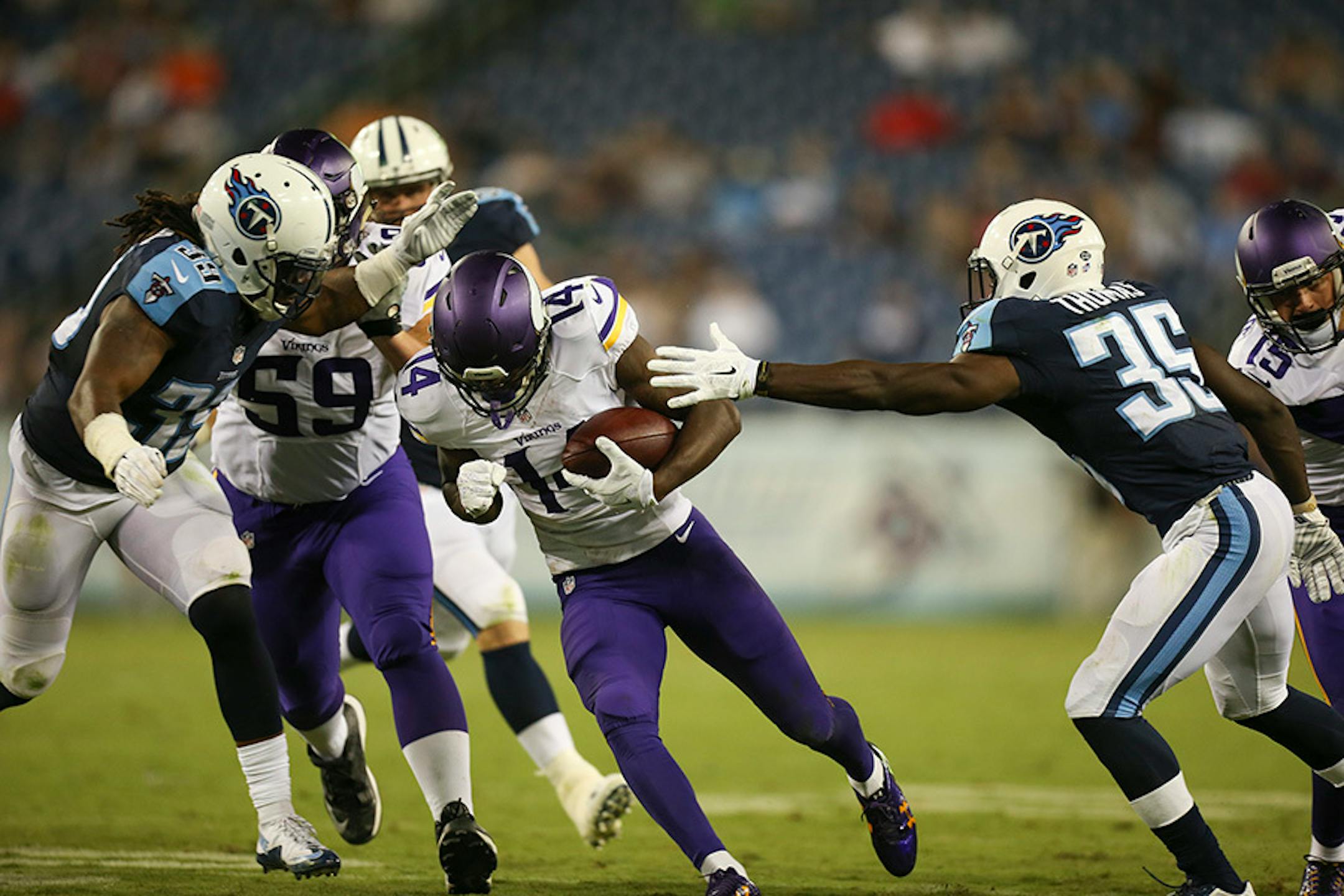 Tennessee Titans strong safety Daimion Stafford (39) and defensive back Jemea Thomas (35)closed in on Vikings wide receiver Stefon Diggs during a preseason game.