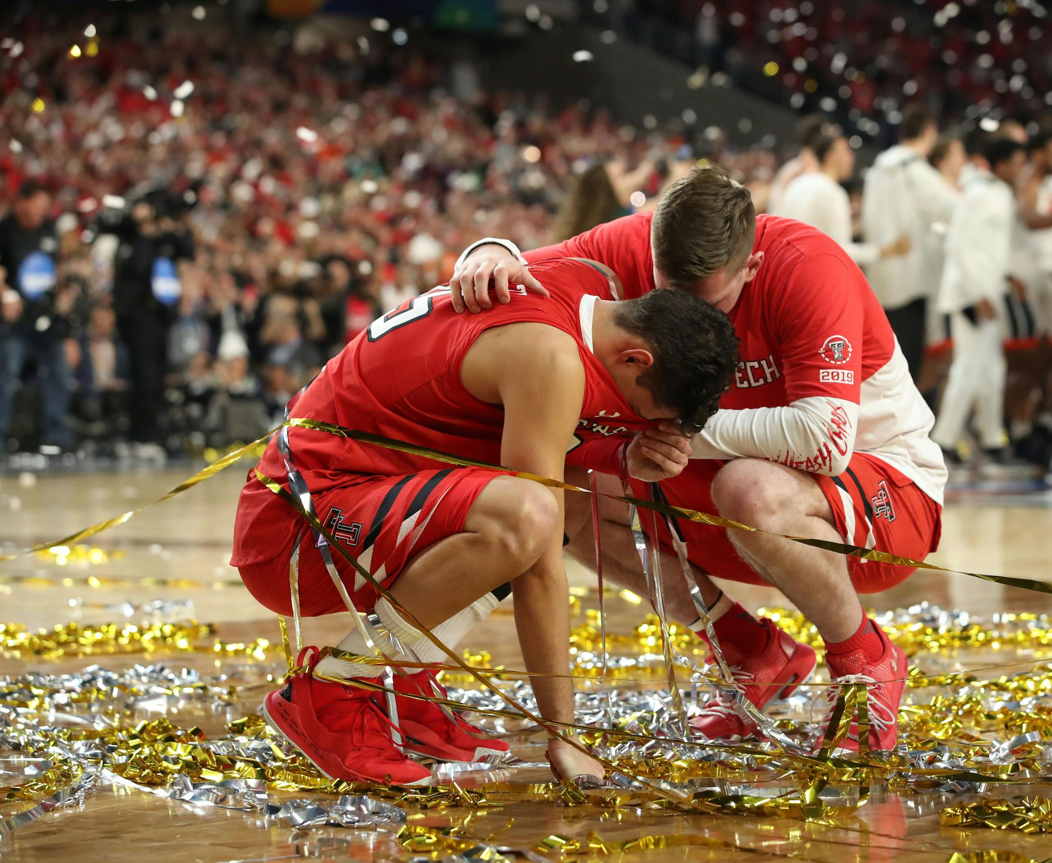 Texas Tech guard Davide Moretti, left, is consoled by a teammate after losing to Virginia. ] CARLOS GONZALEZ &#xa5; carlos.gonzalez@startribune.com Texas Tech played Virginia in the final of the NCAA Division I Men's Basketball Championship Final Four on Monday, April 8, 2019 at U.S. Bank Stadium in Minneapolis. Virginia won 85-77 in overtime.