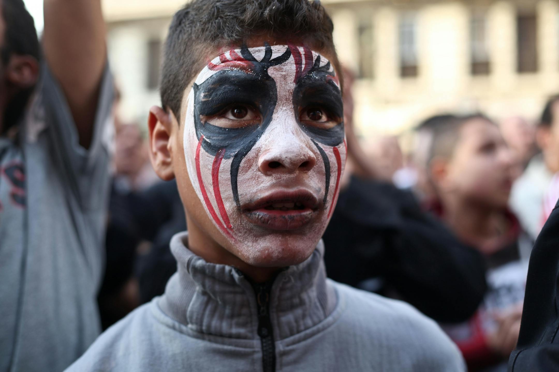 An Egyptian youth wears face paint at a demonstration outside the country's high court in Cairo, Egypt on April 6, 2013. Thousands of activists took to the streets to mark the fifth anniversary of the founding of a leading opposition group, and to push a long list of demands on Morsi, including the formation of a more inclusive government amid a worsening economy.