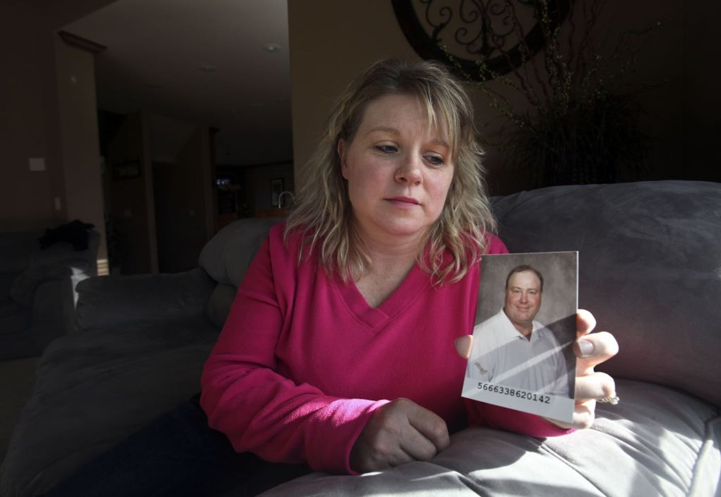 Jodi Rajkowski held a picture of her husband Ron as she sat on Ron's favorite couch in their home in St. Joseph, October, 14 2011. Ron and construction worker for Egan was killed Thursday after being struck by car on I-35W in Burnsville.